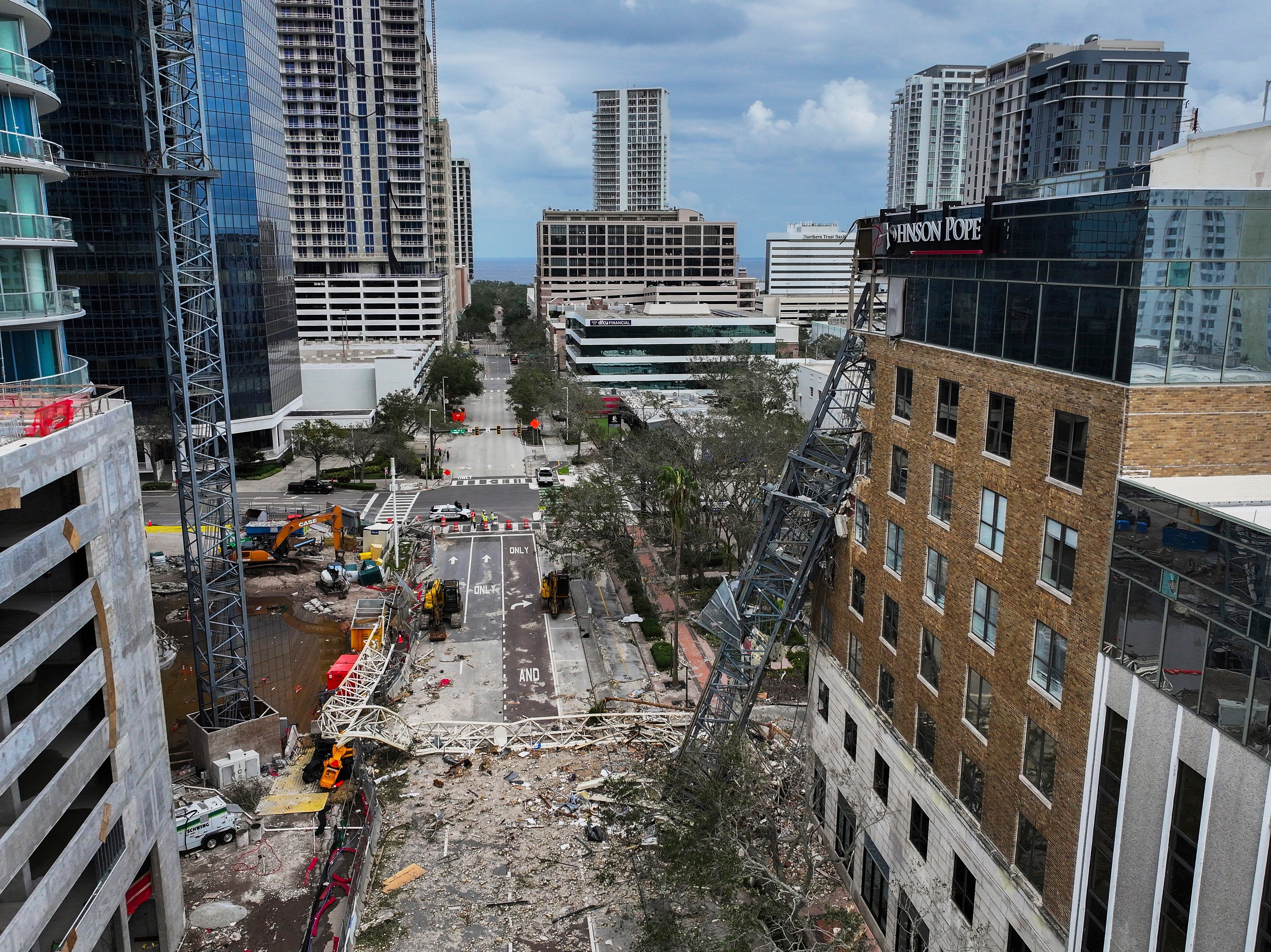 An aerial drone view of the scene where a downtown high-rise was smashed by a fallen crane from Hurricane Milton in St. Petersburg