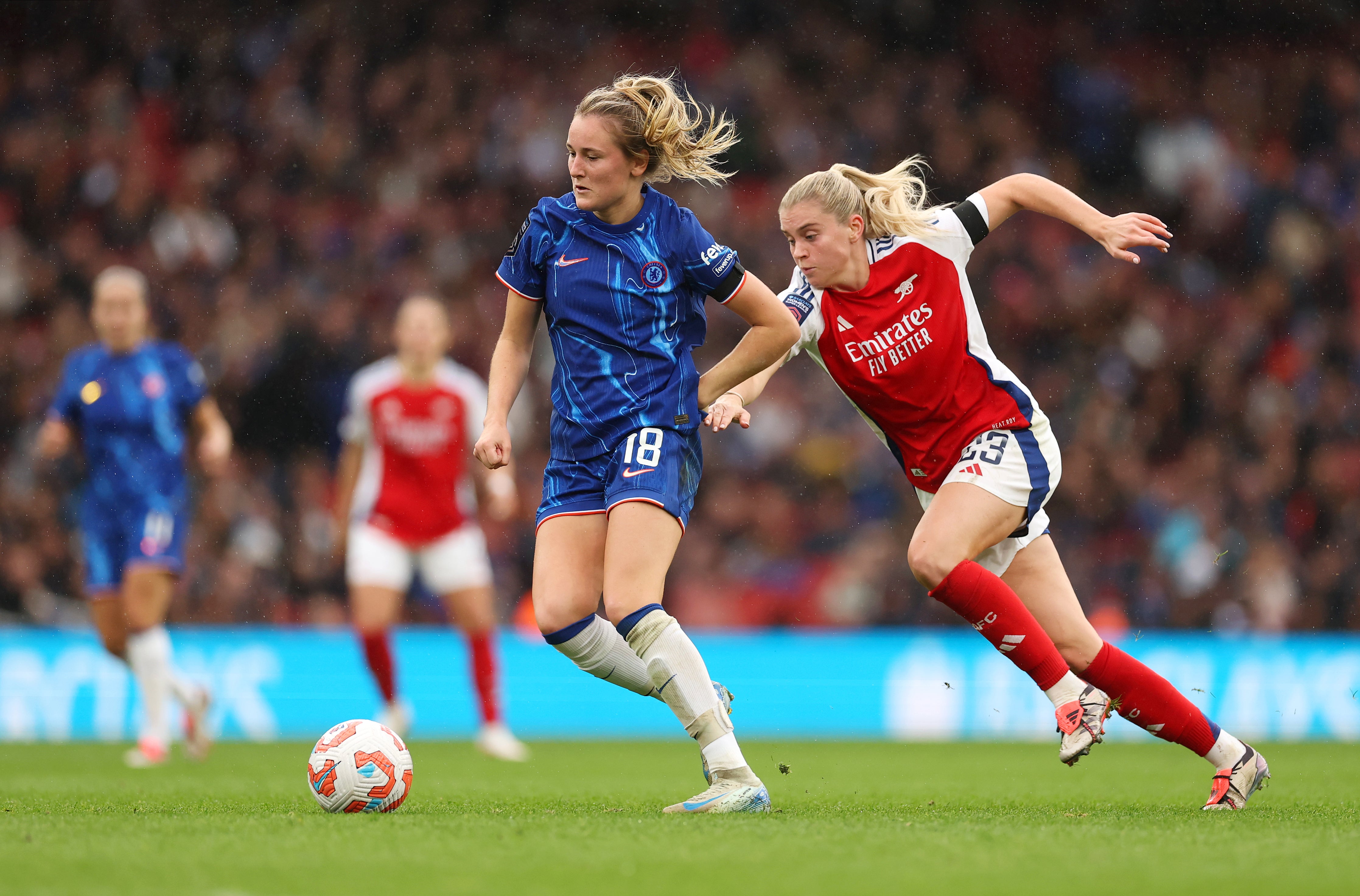 Wieke Kaptein of Chelsea is challenged by Alessia Russo of Arsenal