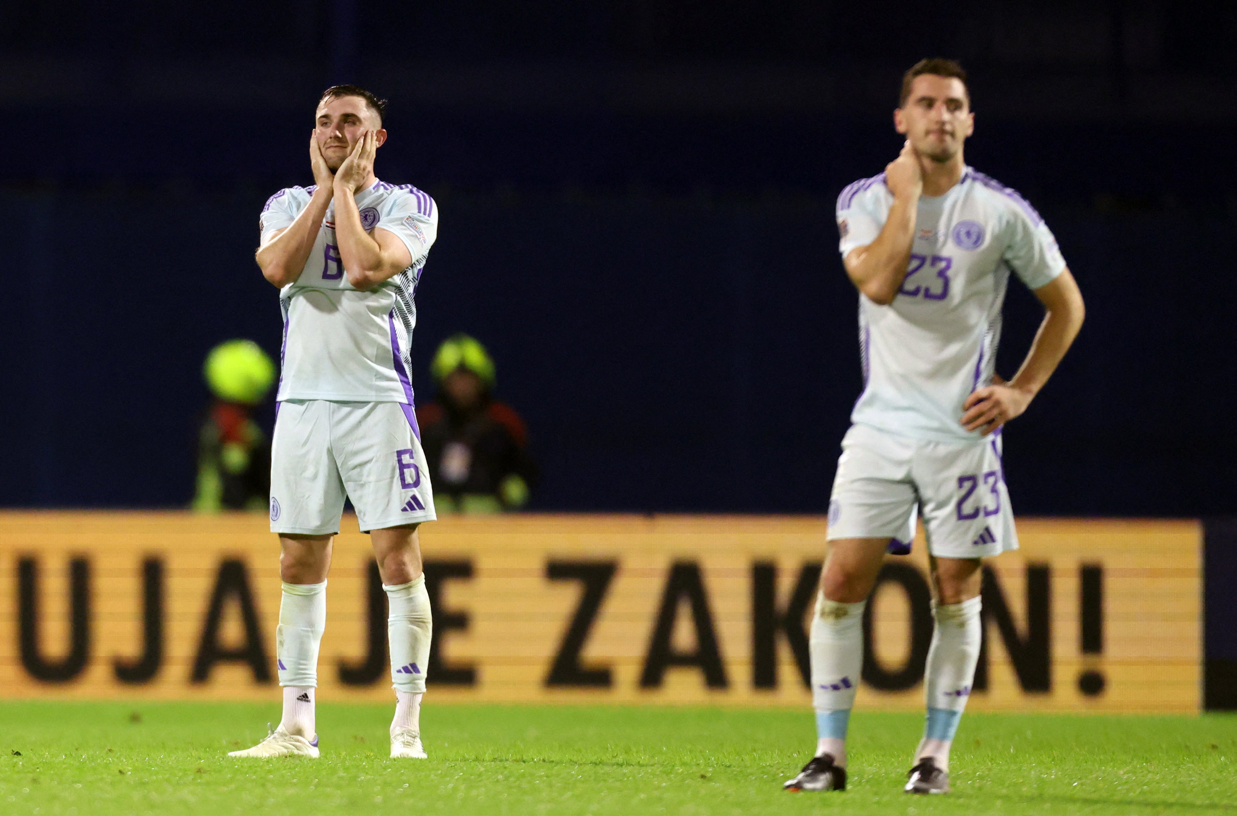 Scotland’s players react after a late equaliser is ruled out for offside