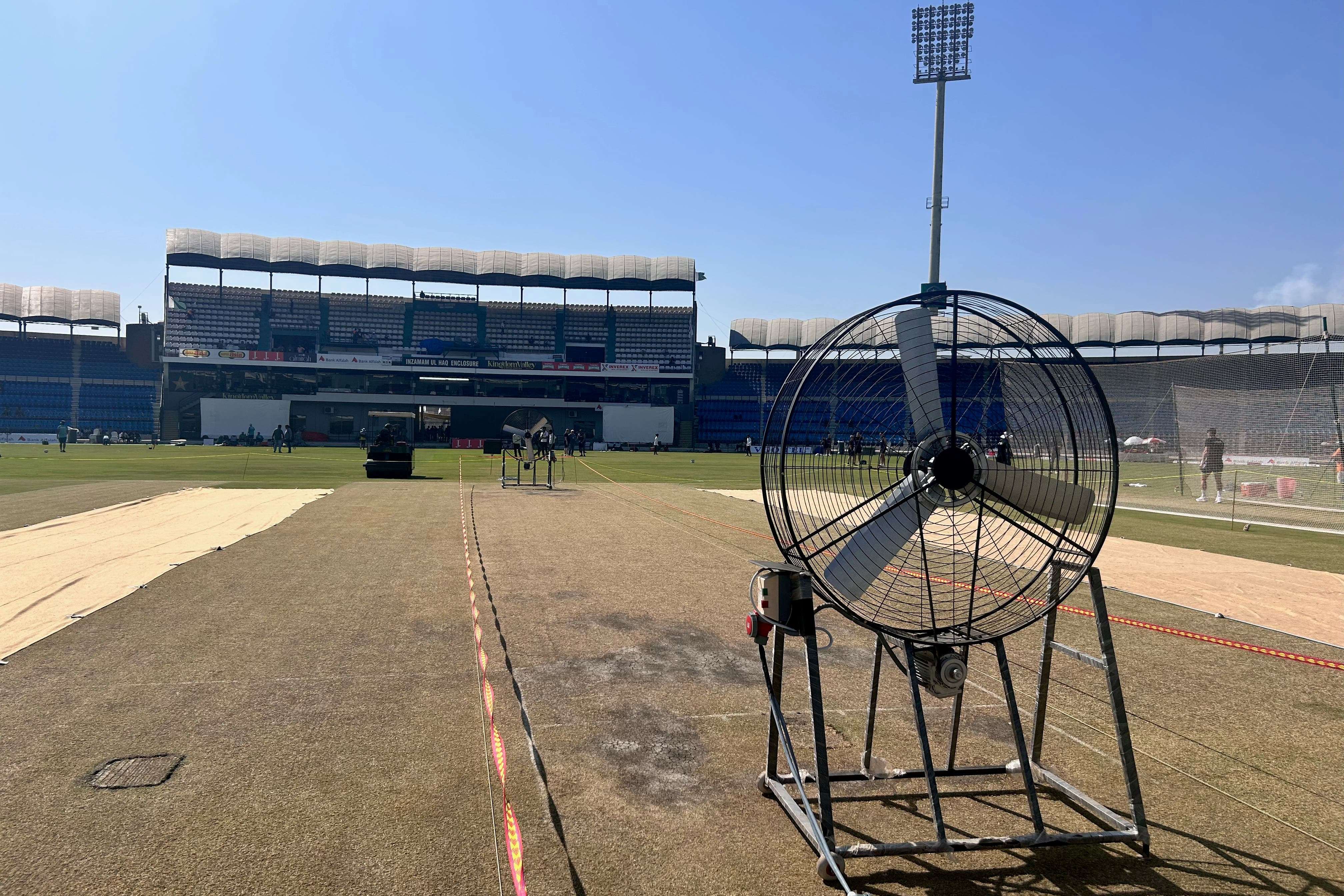 Grounds-staff are drying out the Multan pitch for re-use