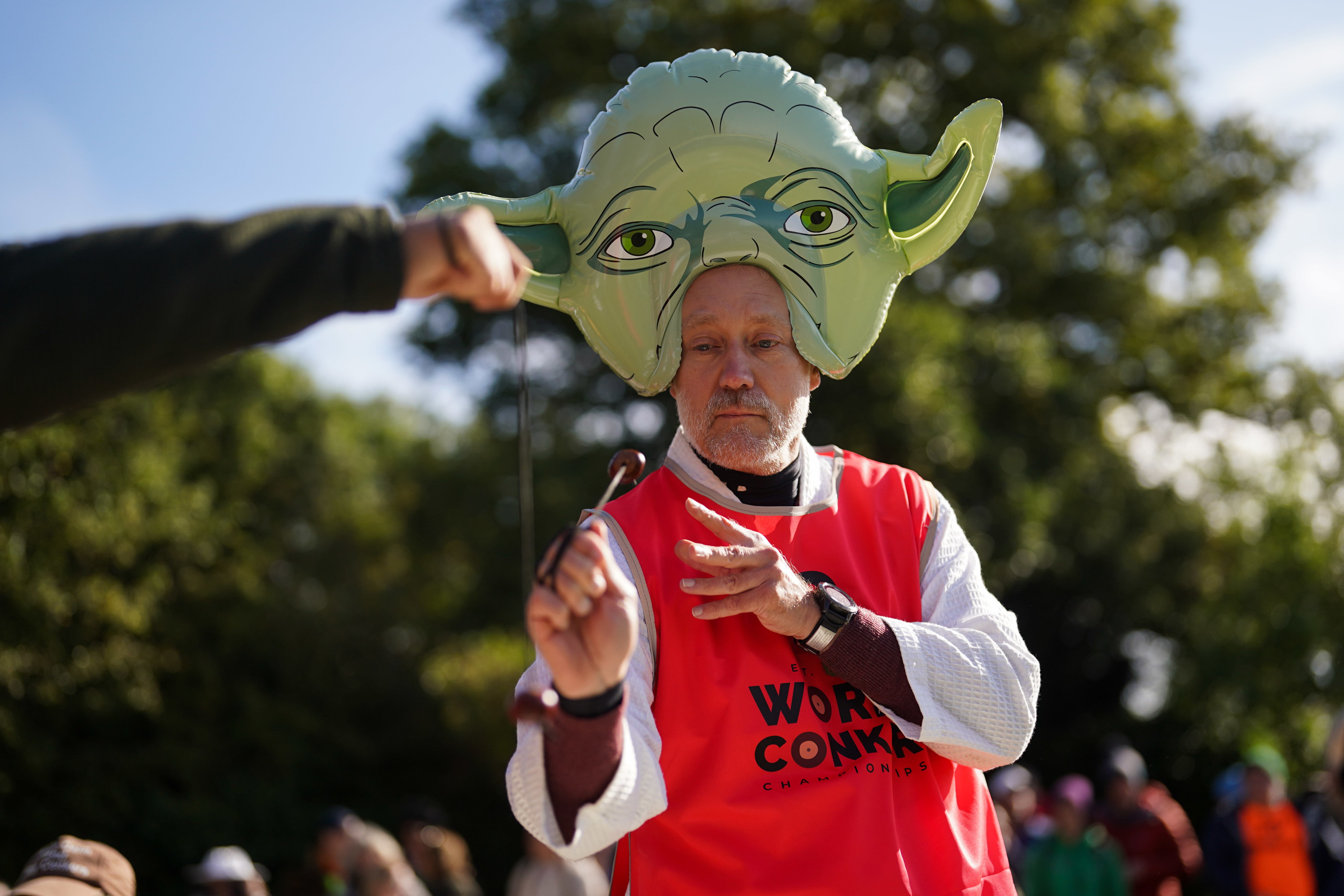 A competitor wearing a Star Wars-themed Yoda costume takes part in the annual World Conker Championships (Jacob King/PA)