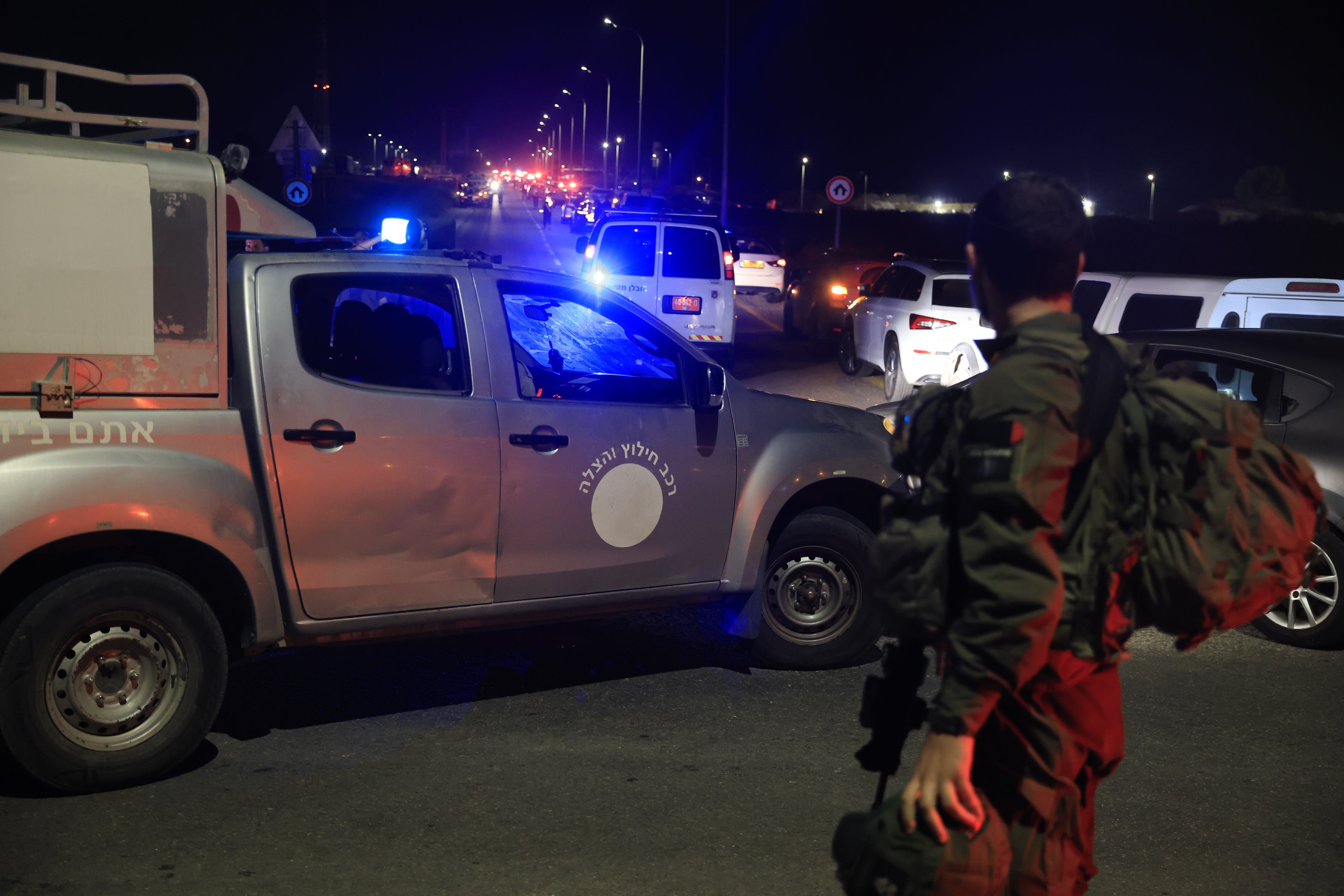 Emergency services personnel attend the scene of a drone strike on Sunday in Binyamina, Israel