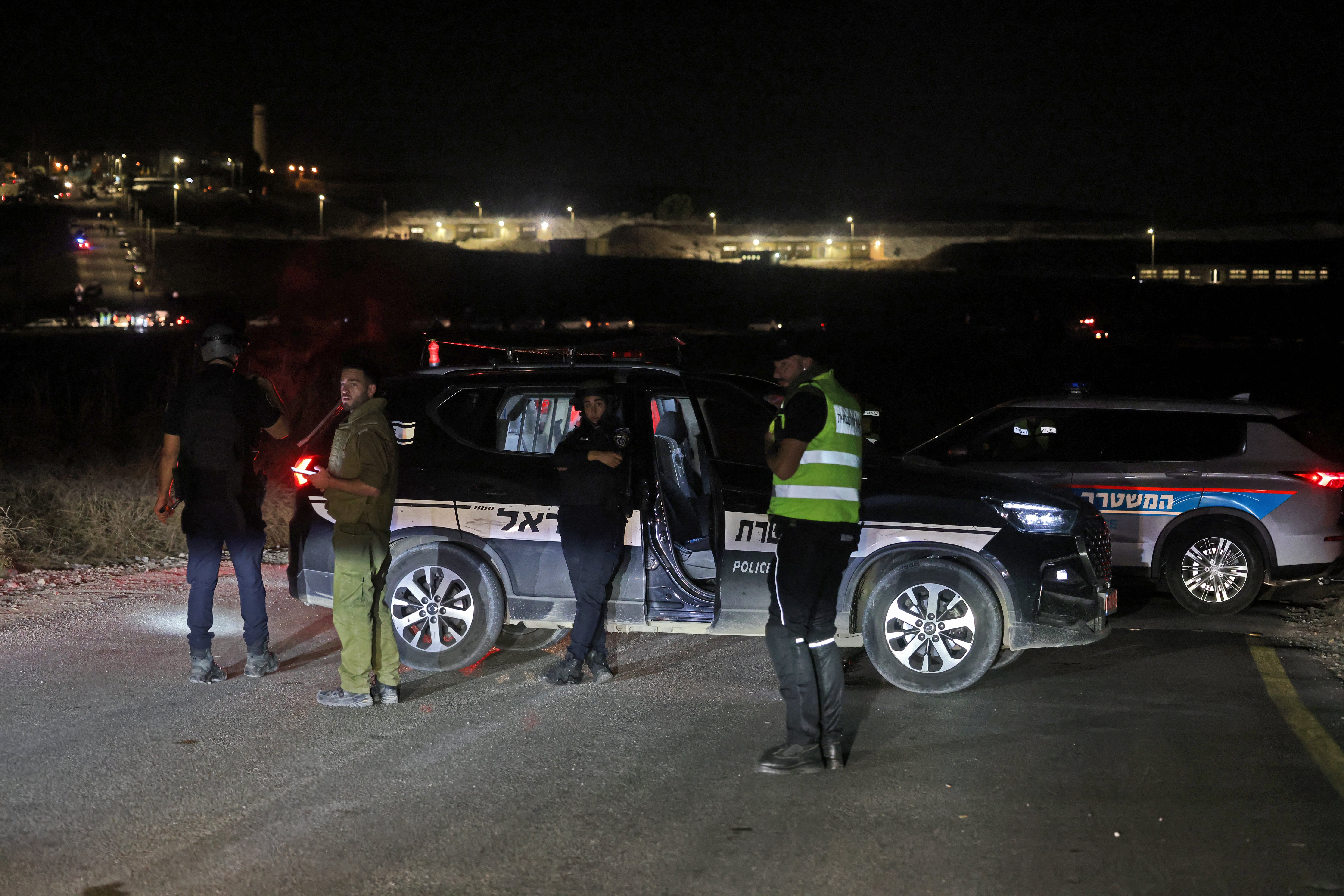 Members of Israel's security forces secure the scene of a drone strike near the northern Israeli town of Binyamina on Sunday