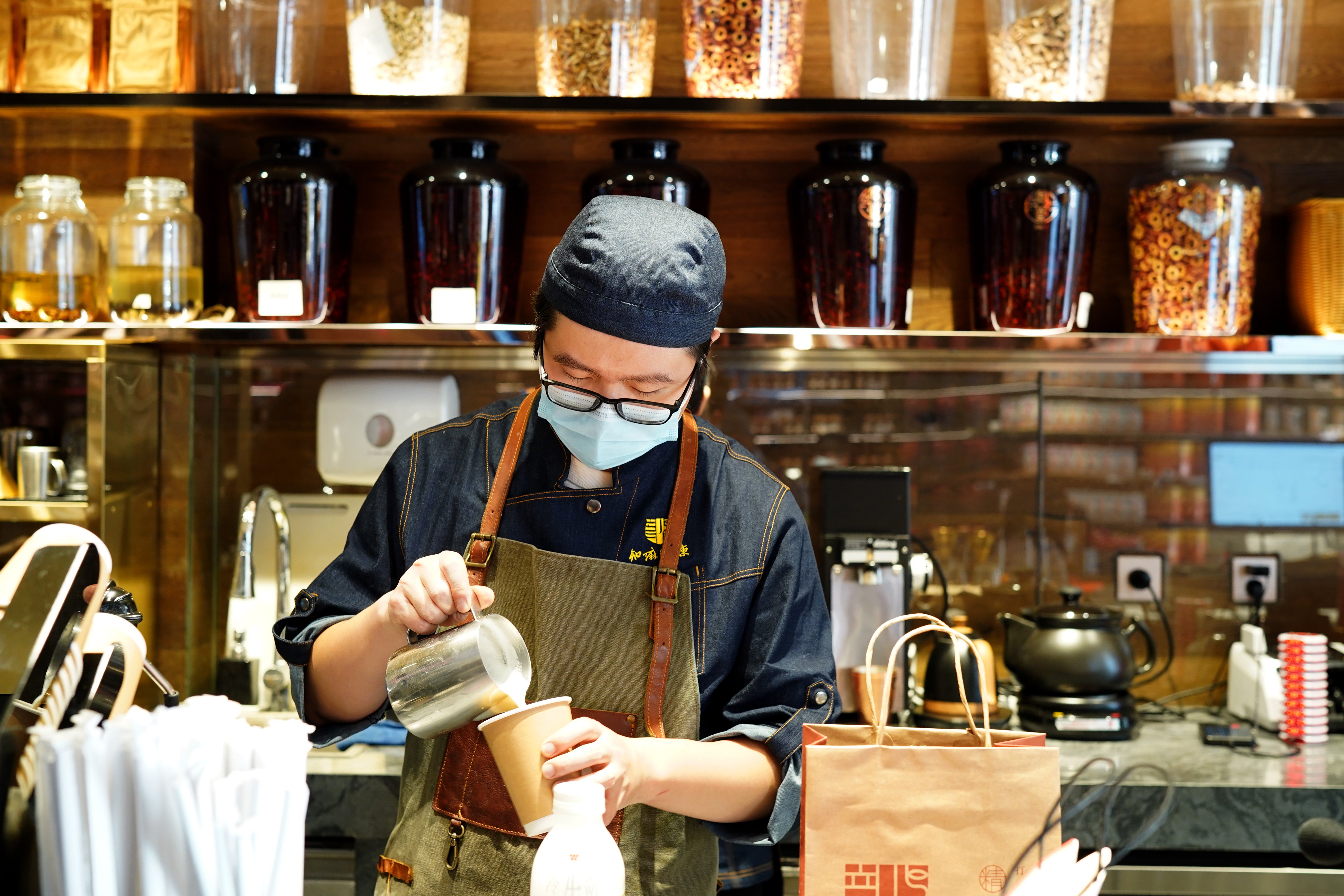 A barista at the Zhima Health coffee bar makes a drink in Beijing