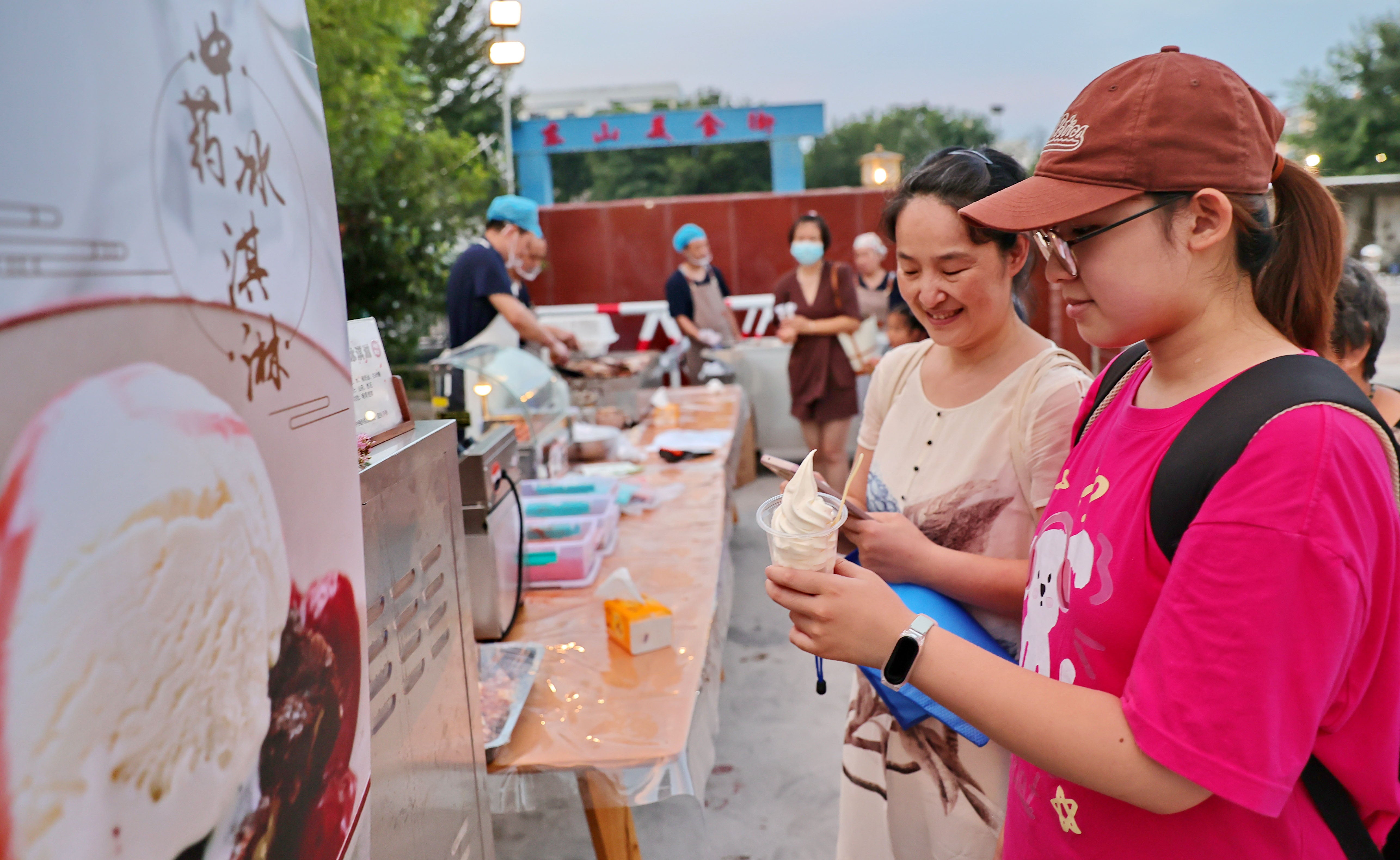 A girl and her mother taste TCM ice cream at a TCM-themed night market in August in Qinhuangdao, Hebei province