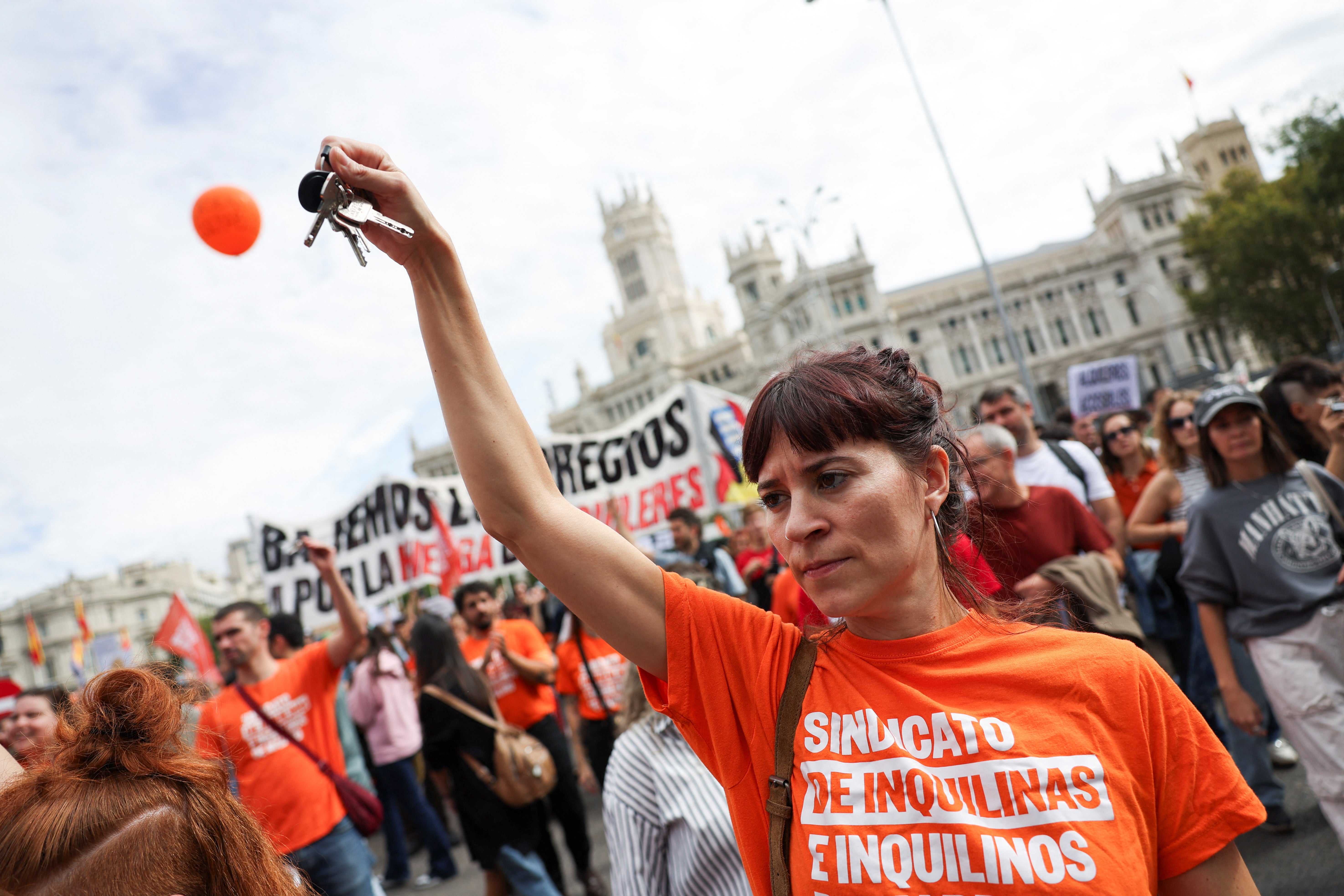 A protester holds keys in her hand during a protest to demand lower housing rental prices and better living conditions