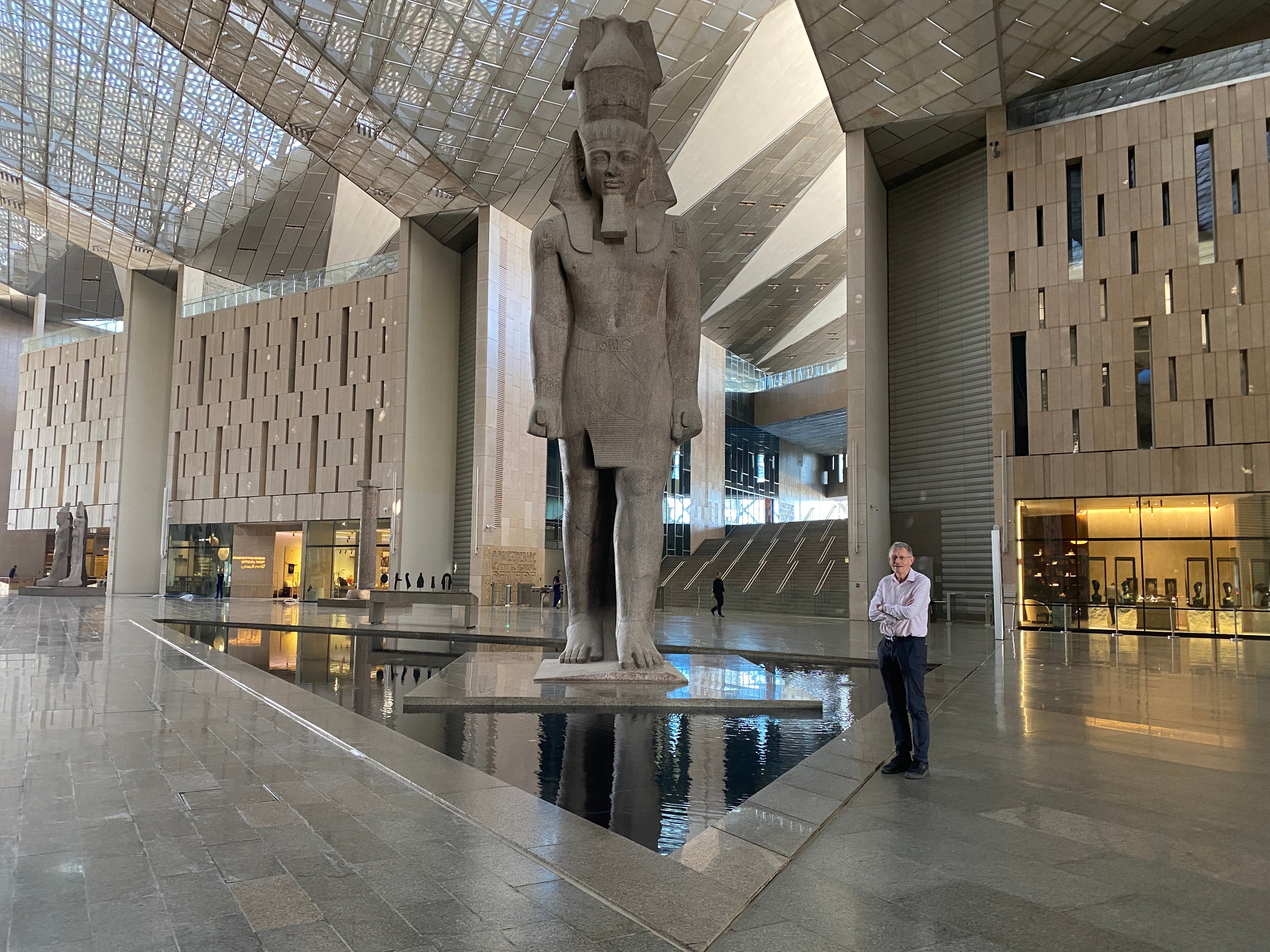 Old relic: Simon Calder (right) and a 36ft-high statue of Ramses II in the atrium of the Grand Egyptian Museum