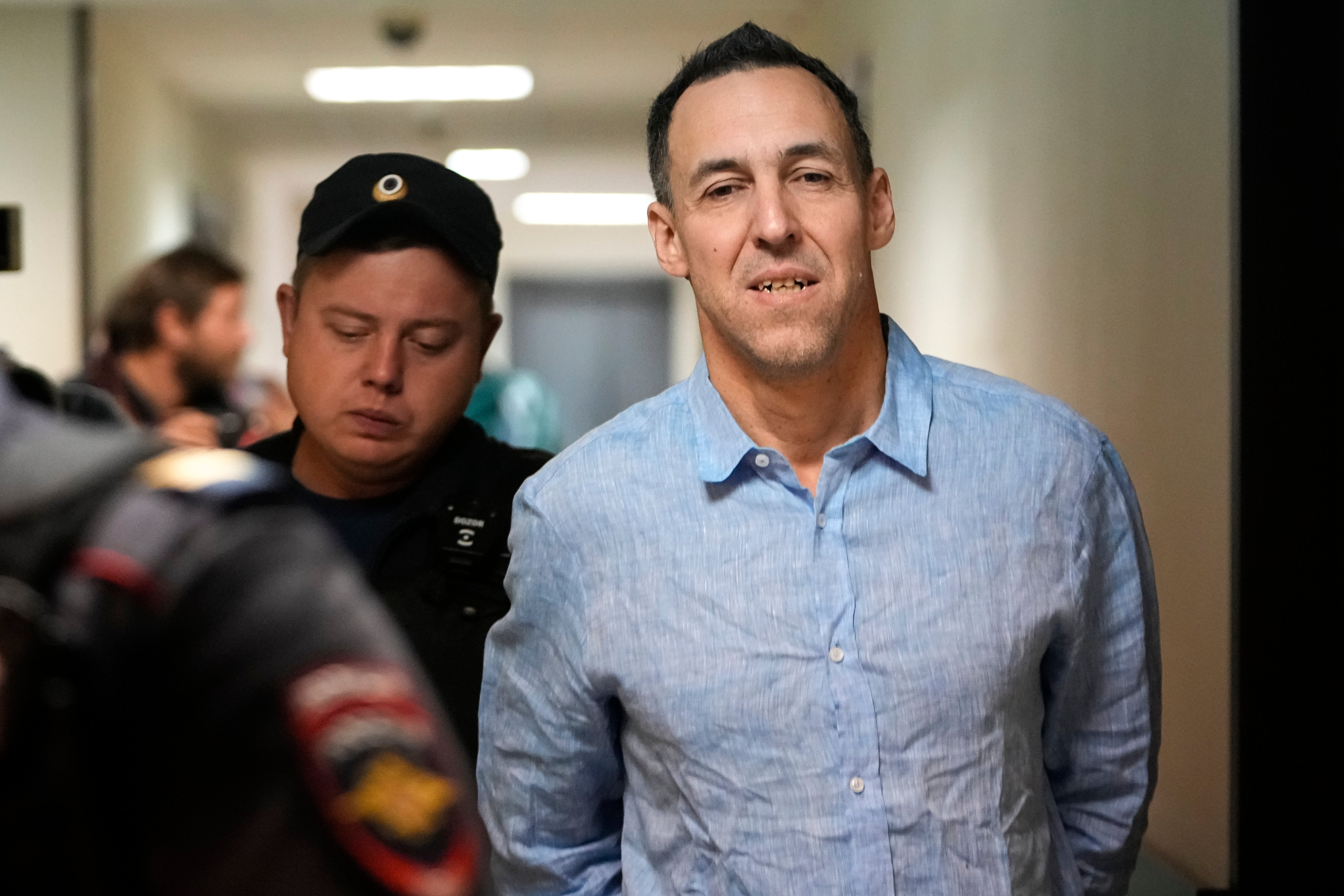 Vinatier is escorted to a court room at the Zamoskvoretsky District Court in Moscow