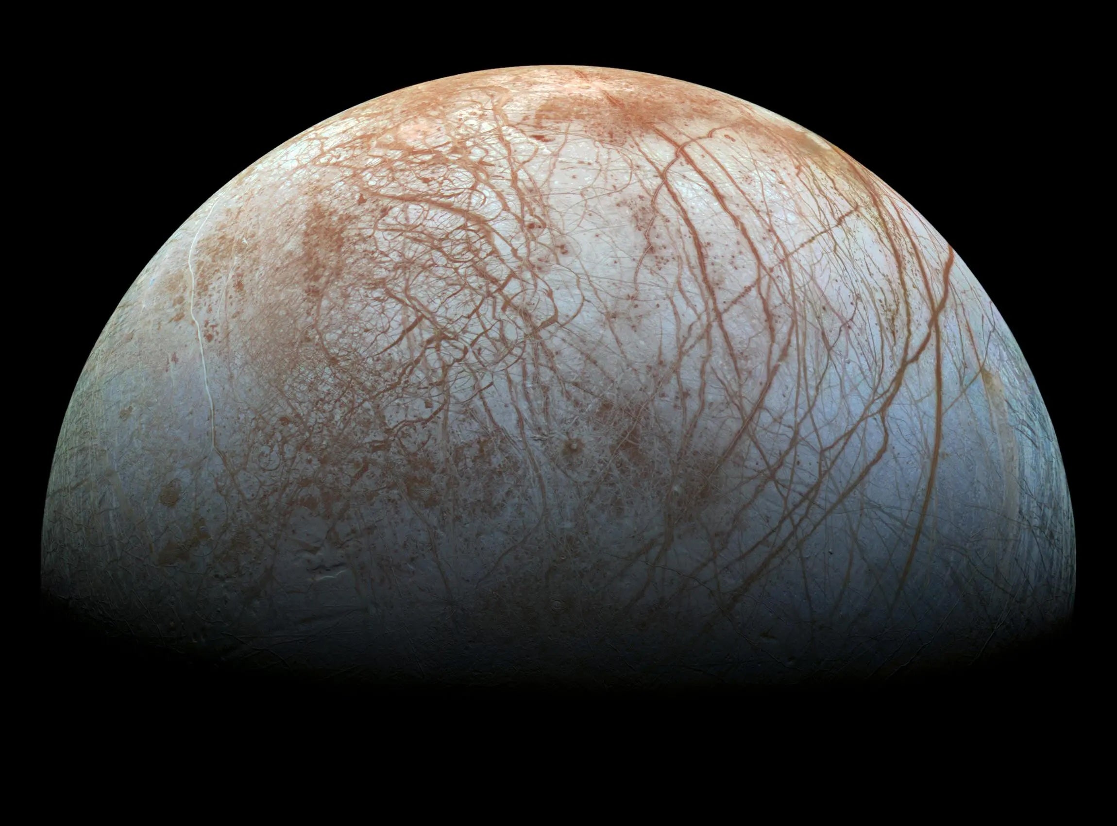 Jupiter’s icy moon Europa looms large in this reprocessed color view made from images taken by NASA’s Galileo spacecraft in the late 1990s. Europa is one of Jupiter’s four largest moons