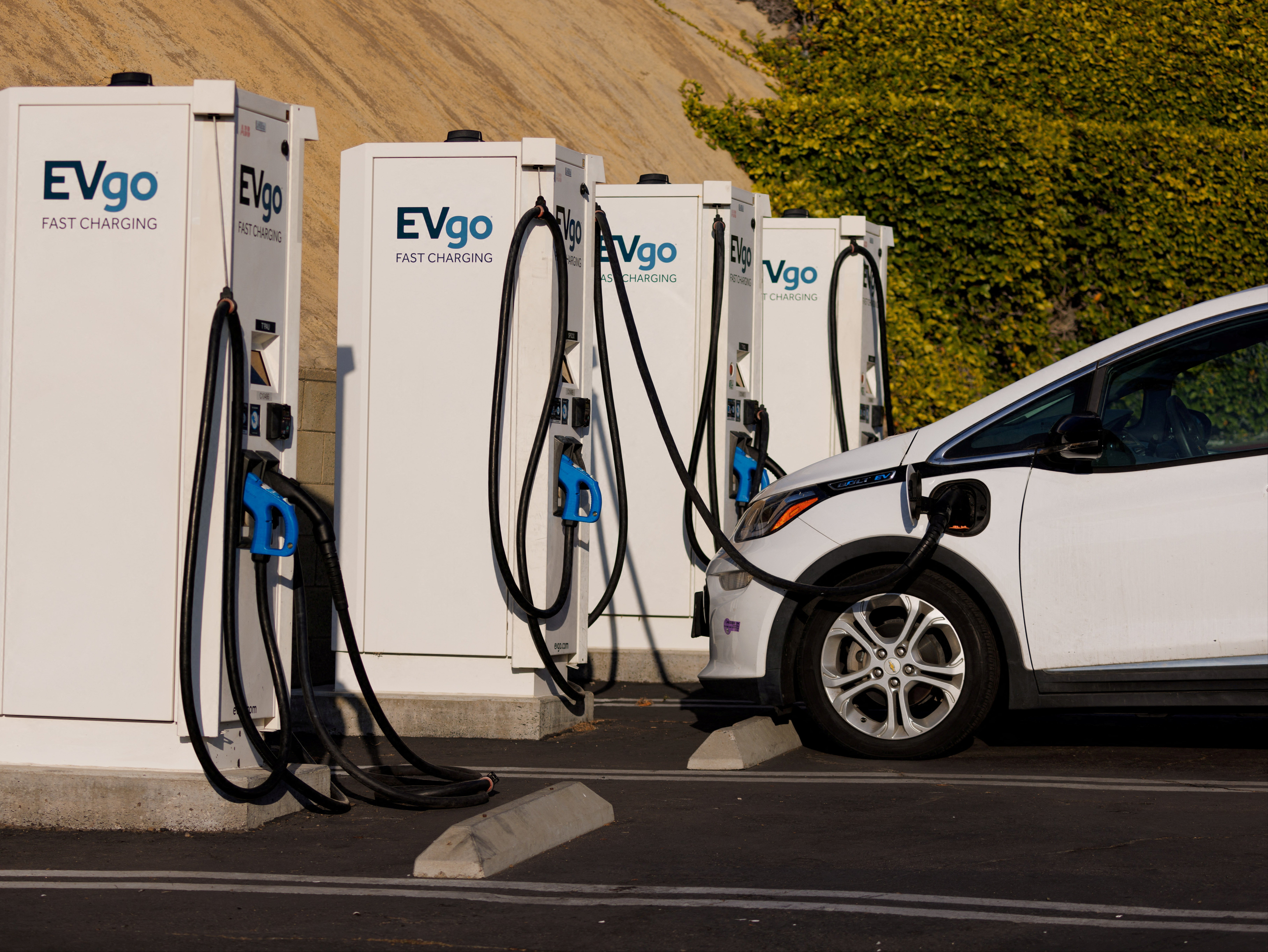 EV chargers refresh a Chevy Bolt in Encintas, California, October 2023. According to reports, a used three-year-old EV now sells for 25 percent less than at the start of 2023