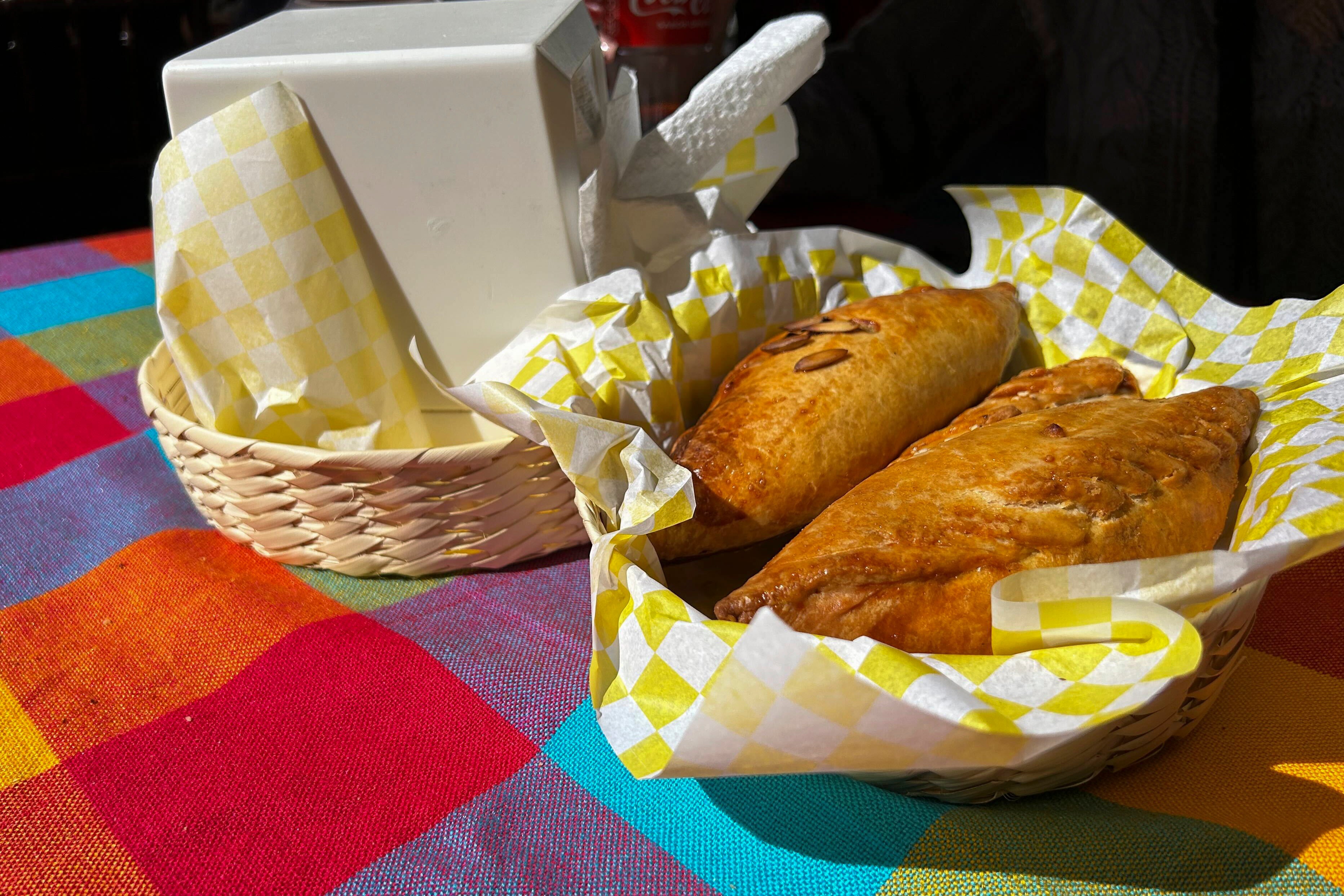 A basket of Mexican pastes sit on a patron's table before they are eated for lunch at the 16th International Paste Festival in Mineral del Monte, Mexico, Saturday, Oct. 12, 2024. (AP Photo/India Grant)