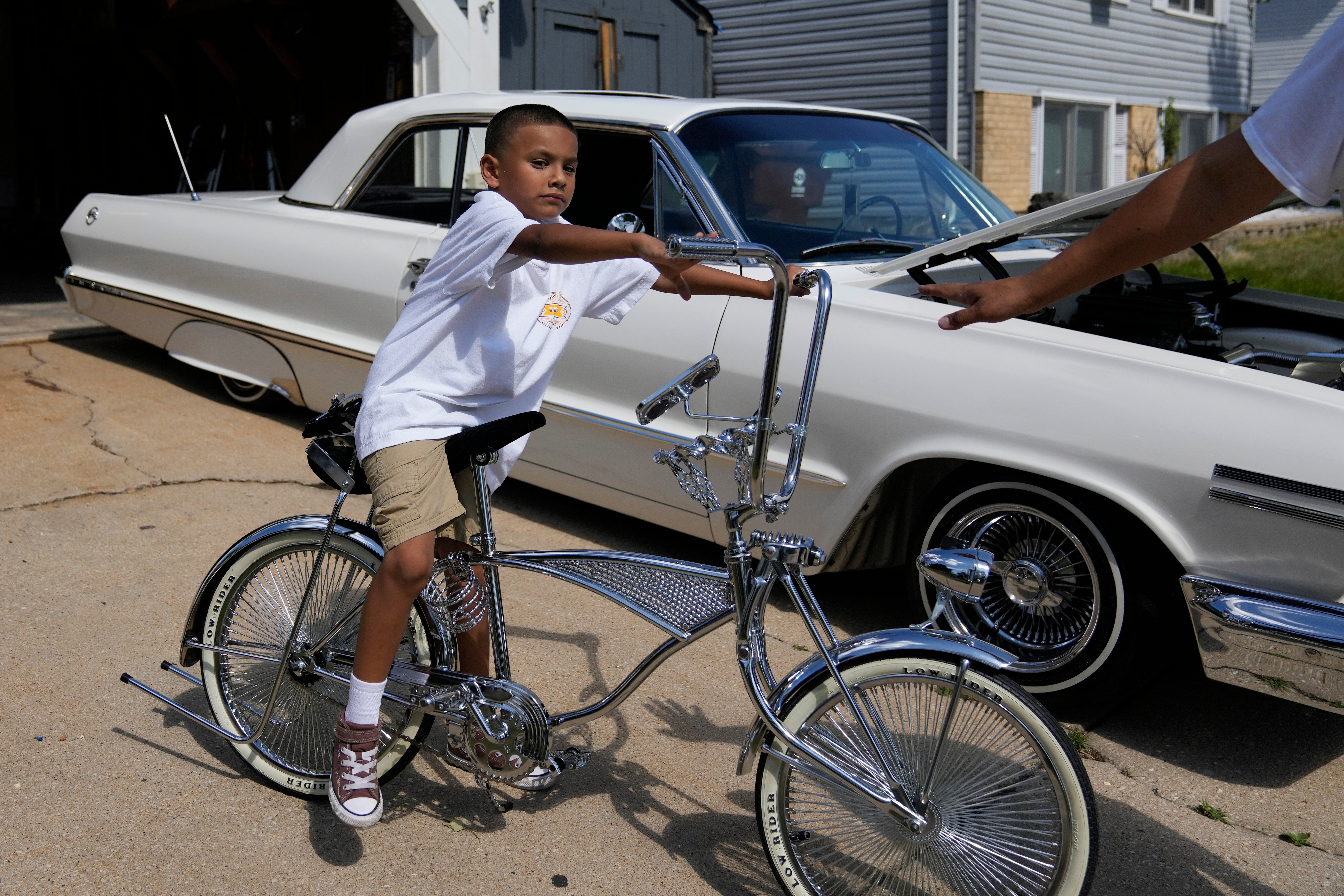 Seven-year-old Daniel Marquez sits on his chrome lowrider bike, custom-built by himself and family friends in memory of his late father Alberto, a longtime member of lowrider car clubs