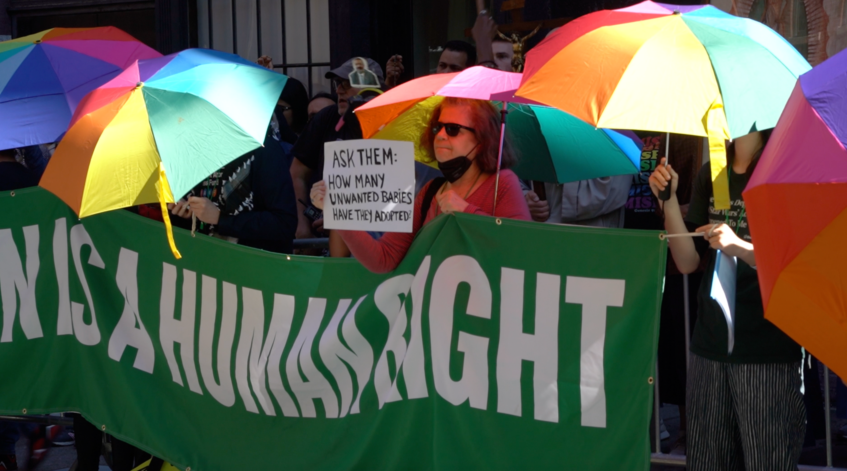 Abortion rights supporters use umbrellas to block anti-abortion demonstrators outside an abortion clinic in New York
