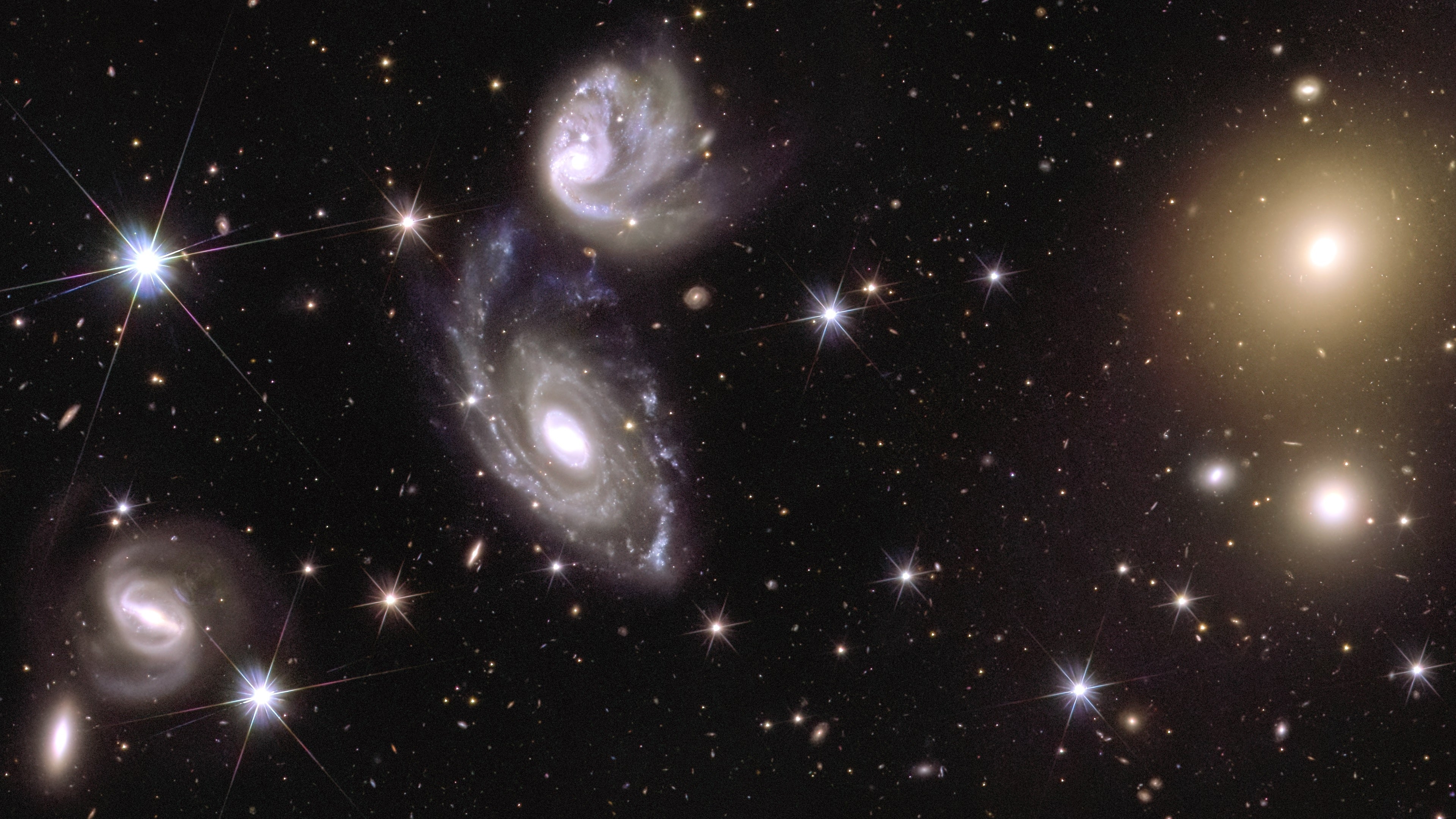 Left. two galaxies, called ESO 364-G035 and G036, that are interacting with each other 420 million light-years away and right, galaxy cluster Abell 3381, 678 million light-years away, captured by the Euclid telescope (ESA/Euclid/Euclid Consortium/NASA/CEA Paris-Saclay/JC Cuillandre/E Bertin/G Anselmi)