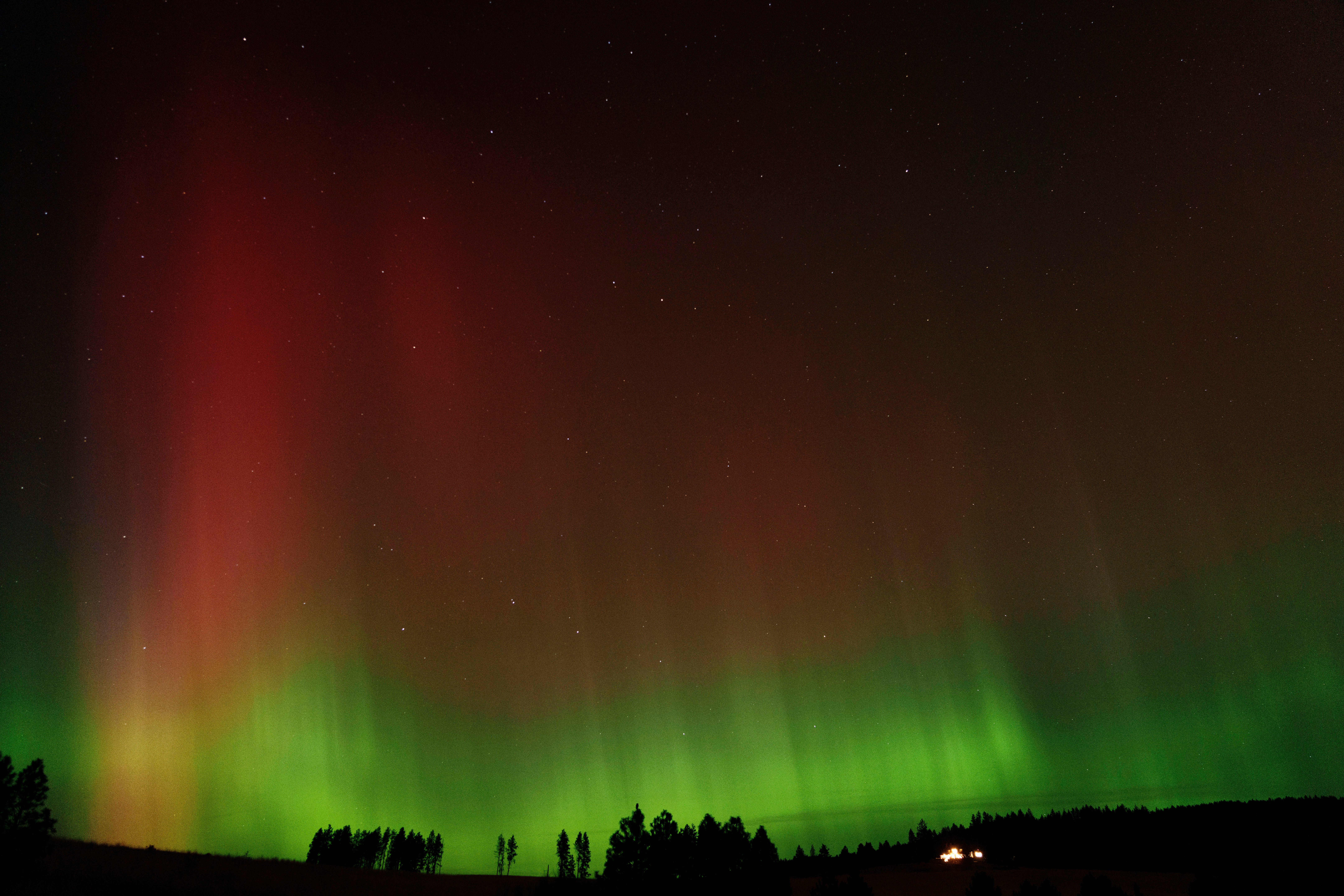 An aurora borealis, also known as the northern lights, is seen in the night sky last week in Moscow, Idaho. Auroras are created when charged particles from the sun collide with Earth's atmosphere