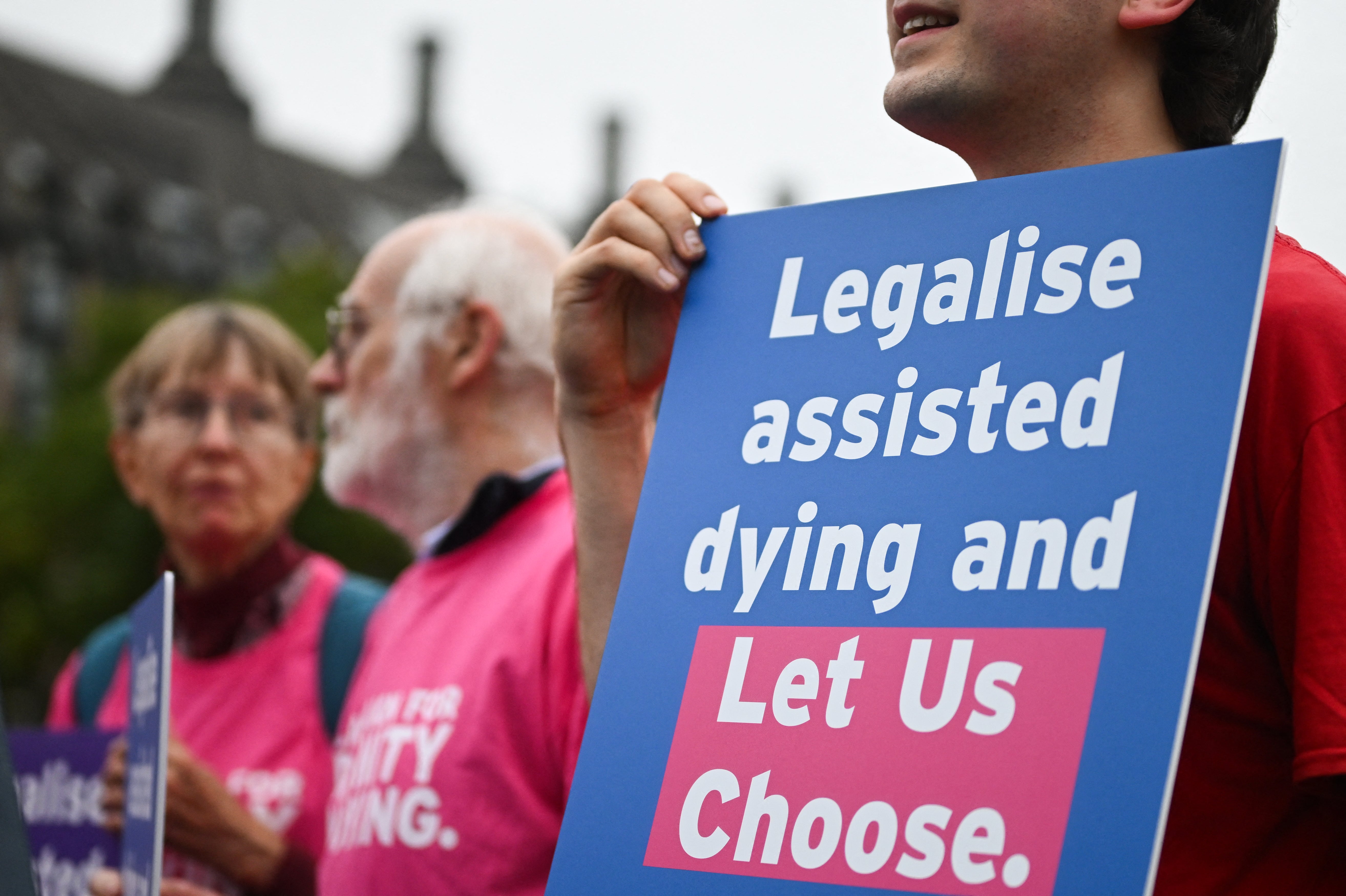 A campaigner from “Dignity in Dying” hold a placard during a demonstration outside The Palace of Westminster