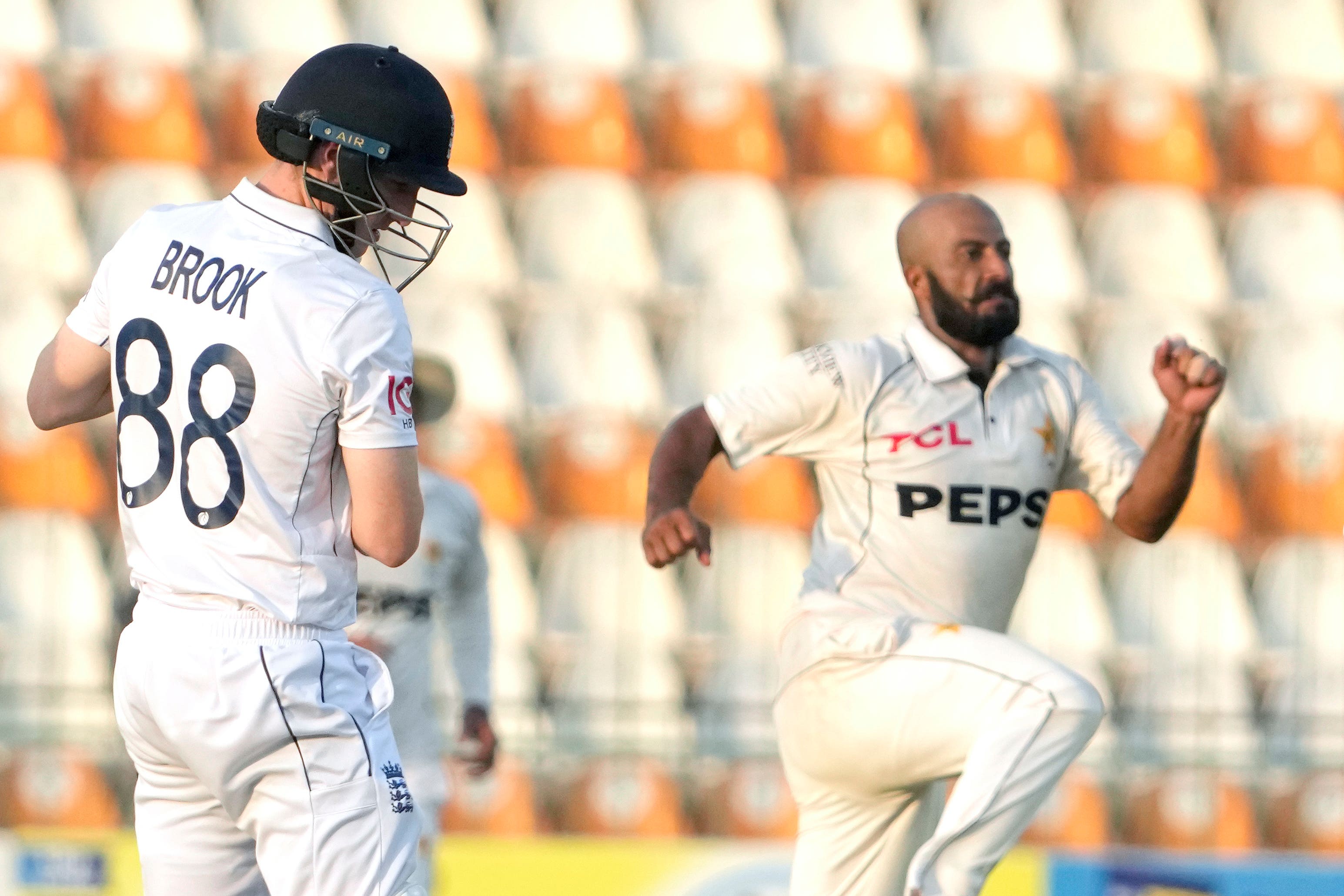 Harry Brook, left, reacts after being bowled by Sajid Khan (KM Chadary/AP)