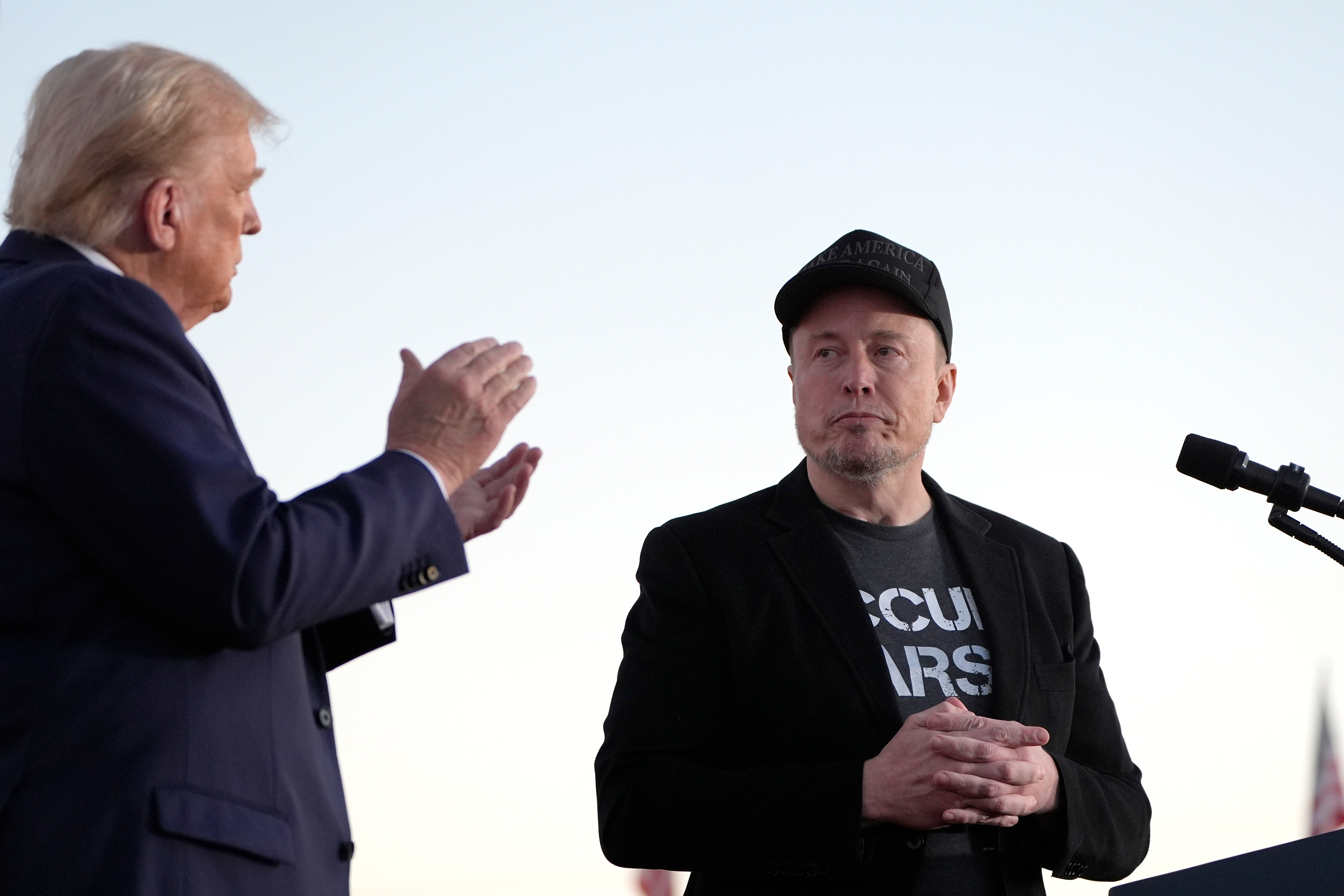 Republican presidential nominee Donald Trump, left, claps as SpaceX CEO Elon Musk prepares to depart after speaking at a campaign event in Pennsylvania earlier this month. Musk endorsed the former president earlier this year, and has shared misinformation spread by Trump.