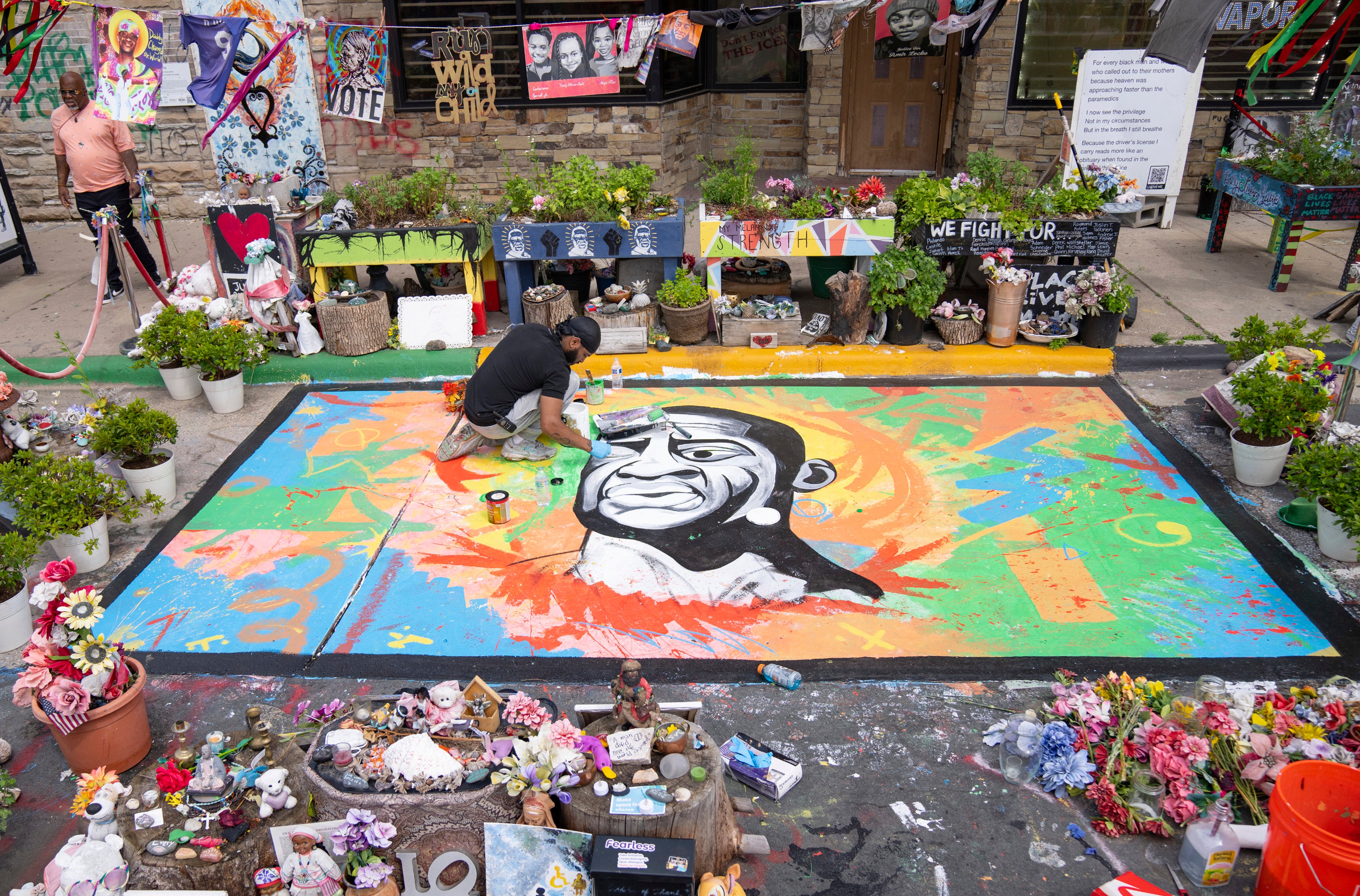 George Floyd Teacher Antonio Jenkins paints a mural of George Floyd at the site where he was murdered by a police officer