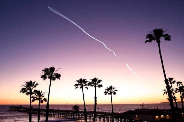 <p>A SpaceX Falcon 9 rocket flies above the Pacific Ocean carrying a payload of 22 Starlink internet satellites into space after launching from Vandenberg Space Force Base on April 1, 2024 as seen from San Clemente, California</p>