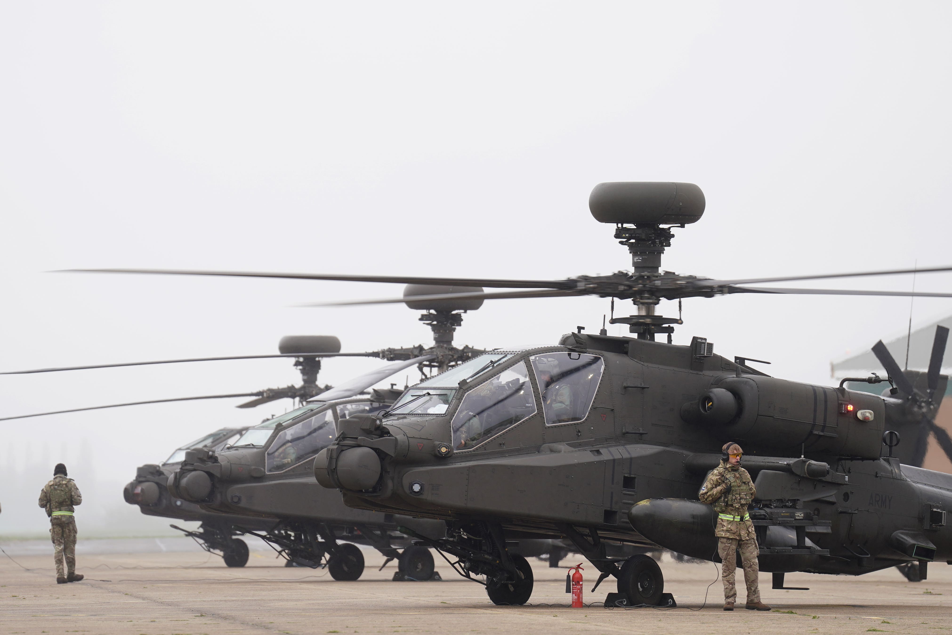 British Army Apache AH-64E attack helicopters are prepared for take off (PA)