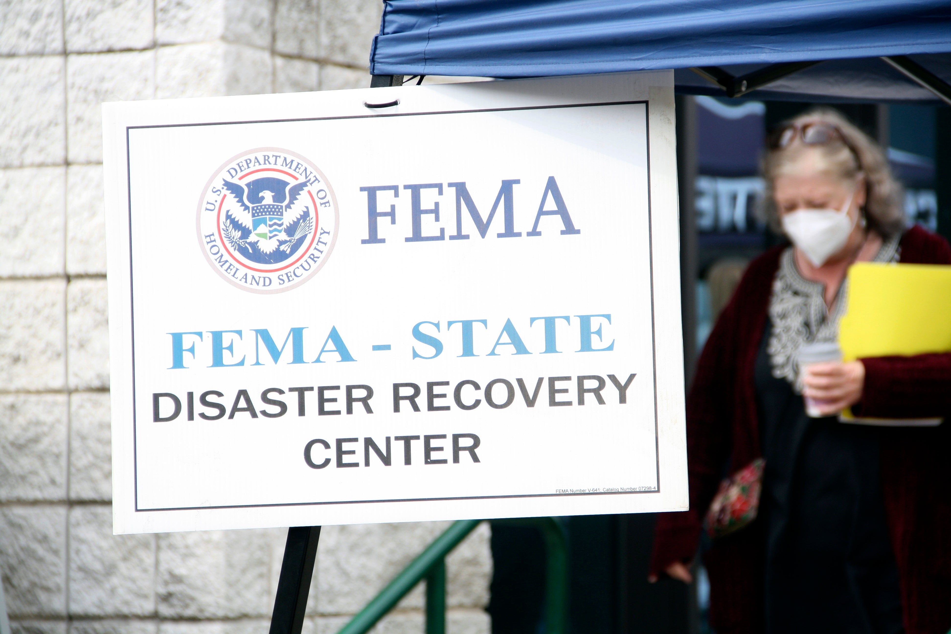 On Tuesday, people gather at a FEMA Disaster Recovery Center at AC Reynolds High School in Asheville, North Carolina. After operational changes were made to keep FEMA members safe over the weekend, workers were knocking on doors again this week.