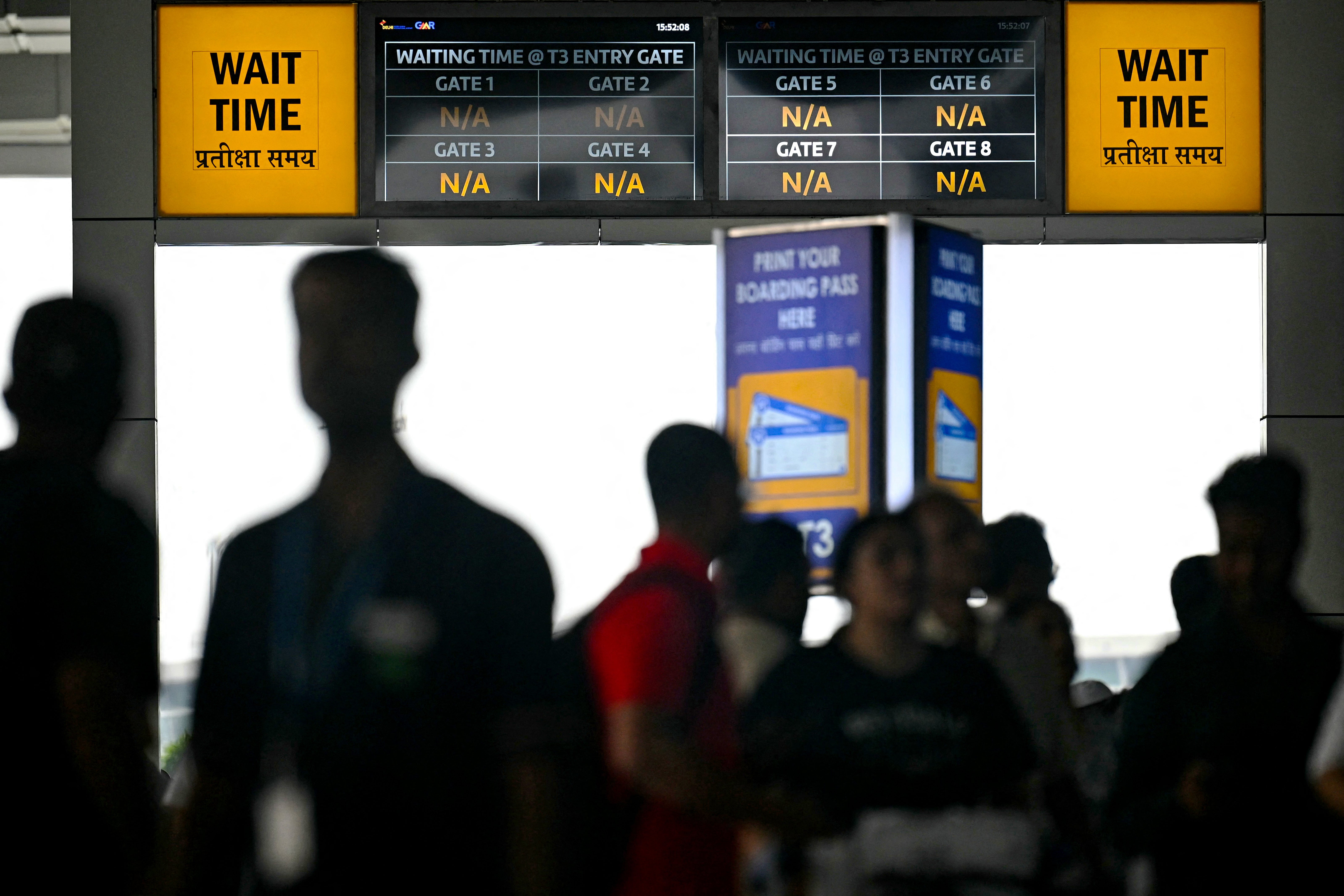 A display screen shows flight information at the New Delhi airport on 19 July 2024