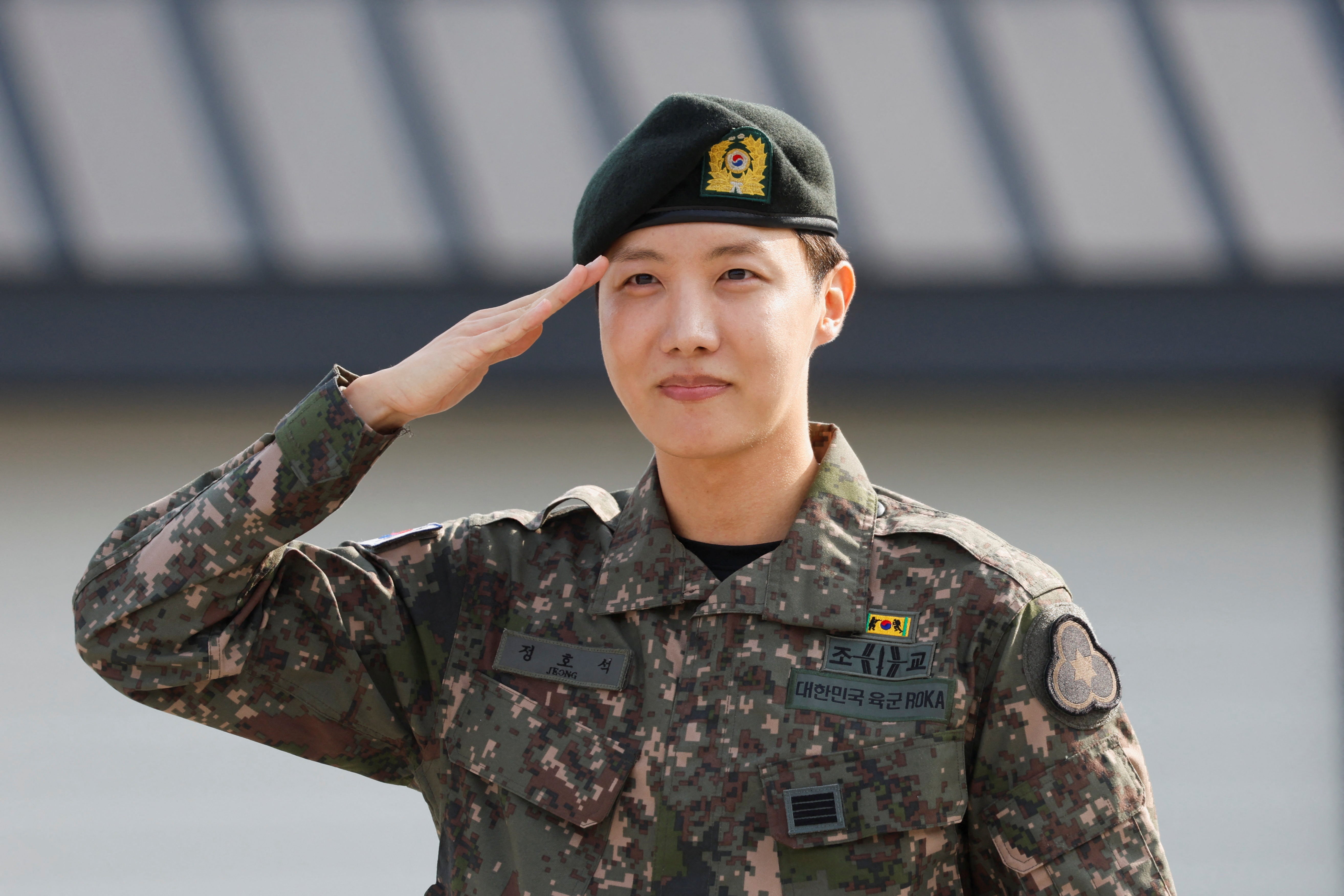 K-pop boy band BTS member J-Hope salutes after being discharged from his mandatory military service outside a military base in Wonju