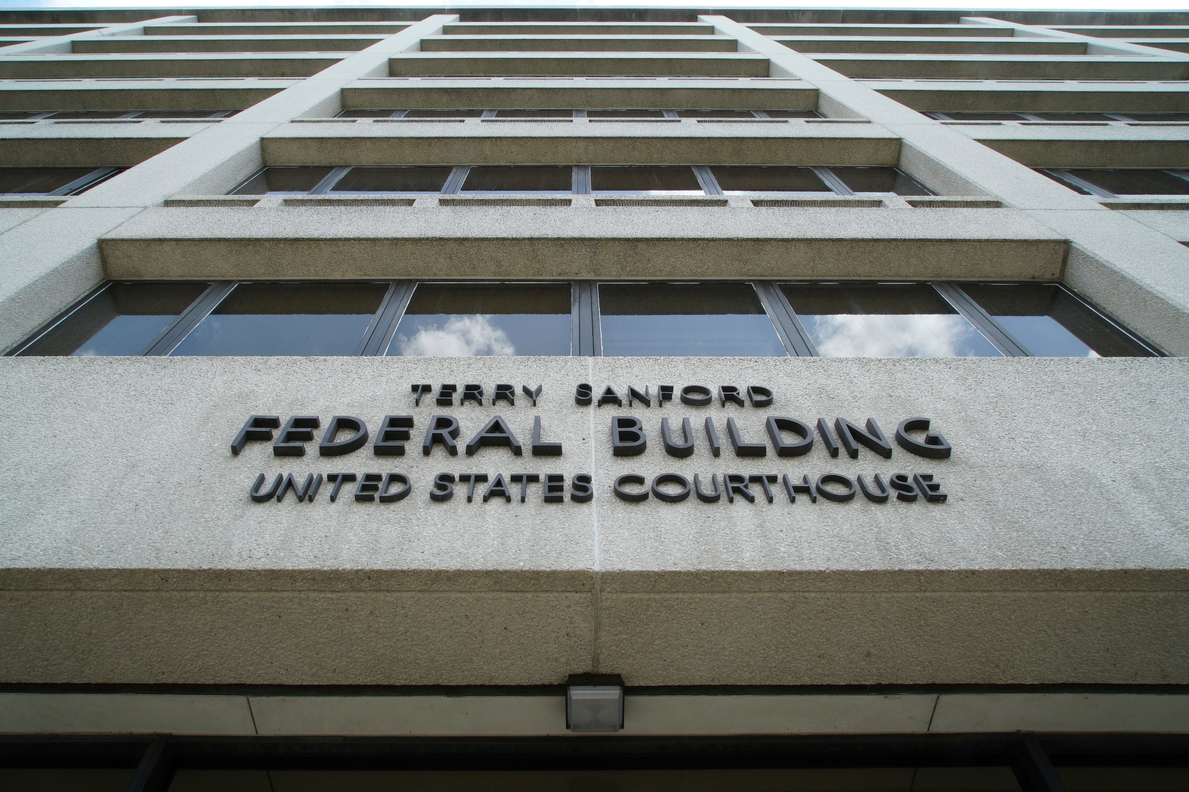 Clouds are reflected in the windows of the federal courthouse in downtown Raleigh, N.C