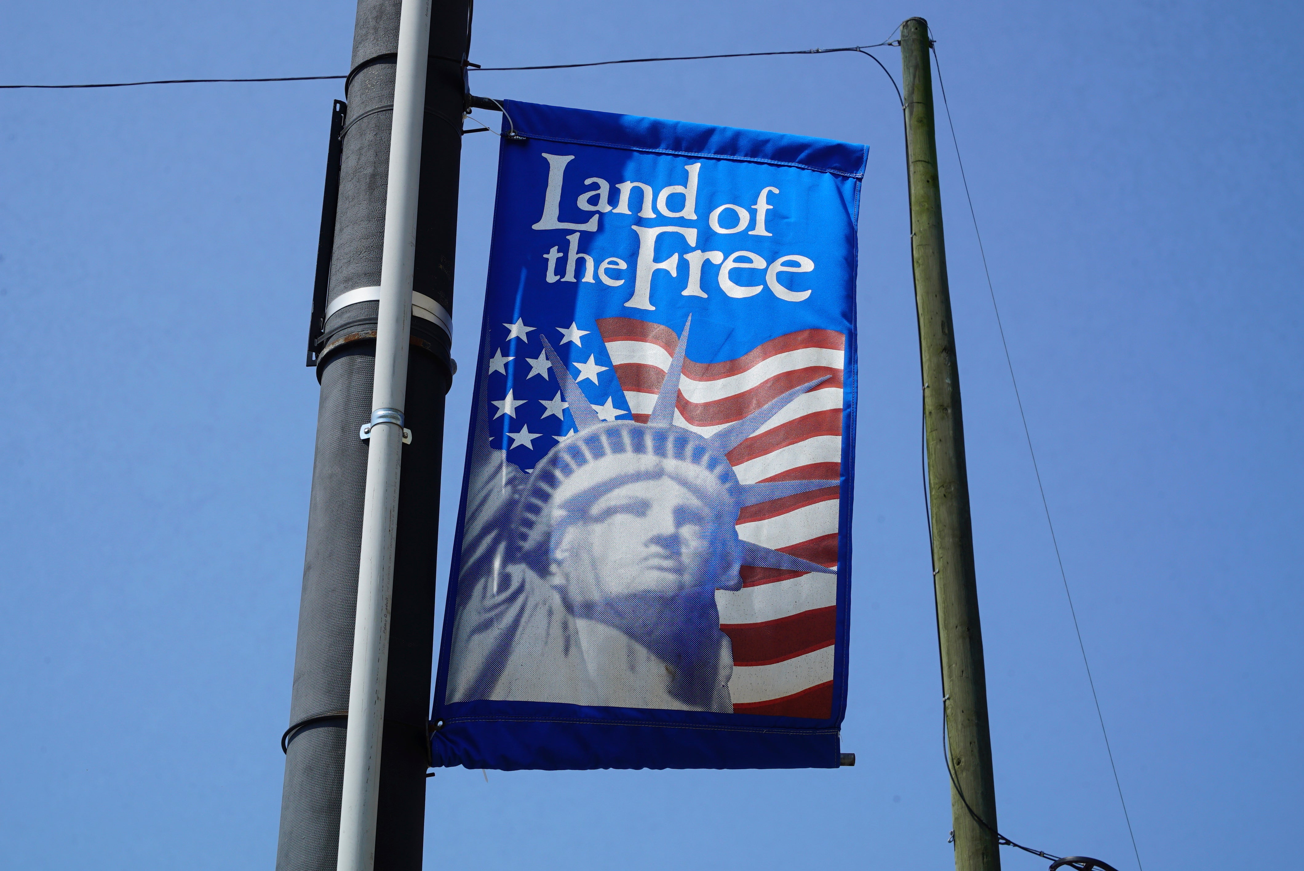 A patriotic banner hangs from a utility pole in downtown Mount Olive,