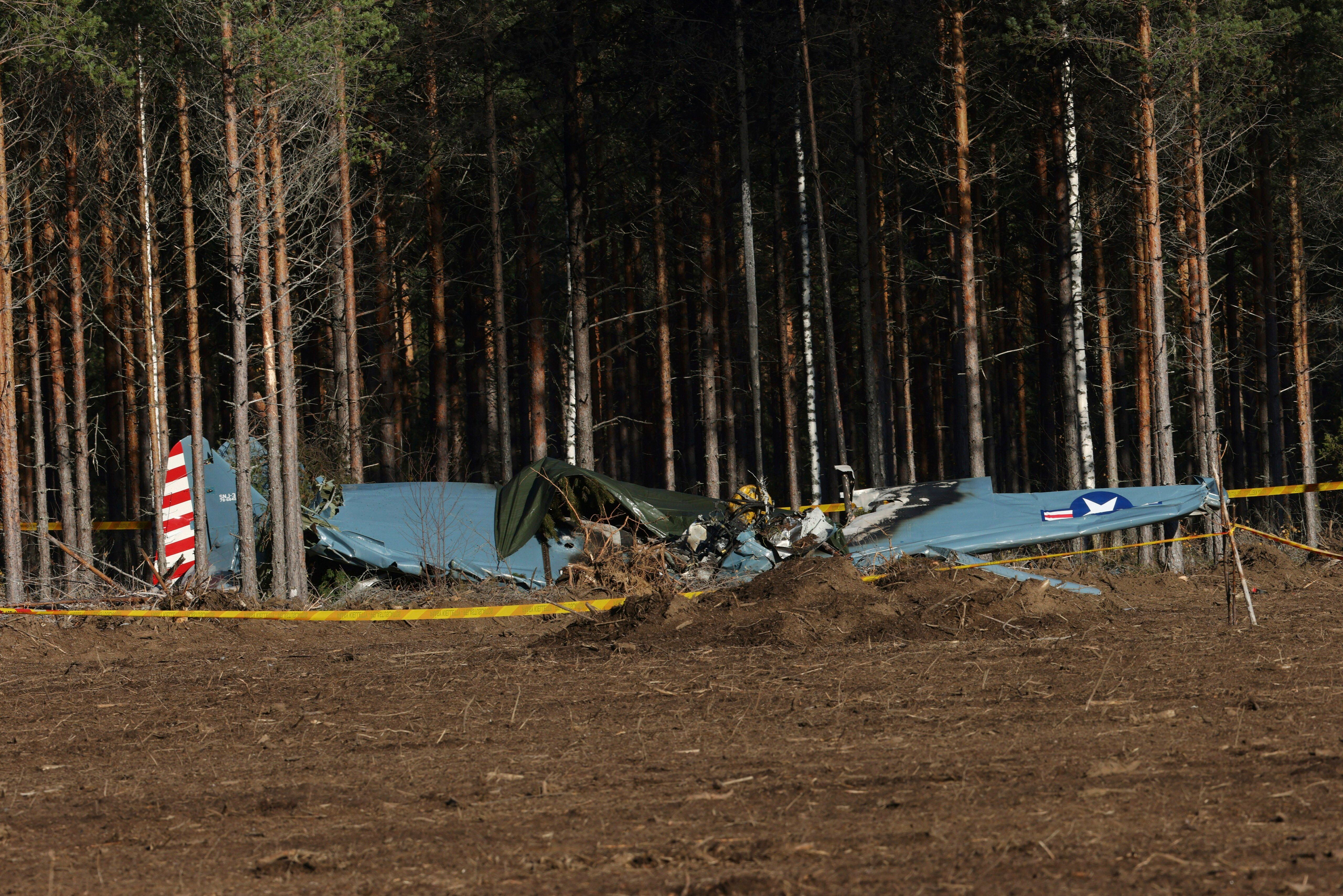 A World War II-era airplane is seen after crashing minutes after takeoff, near the Rayskala aviation airfield