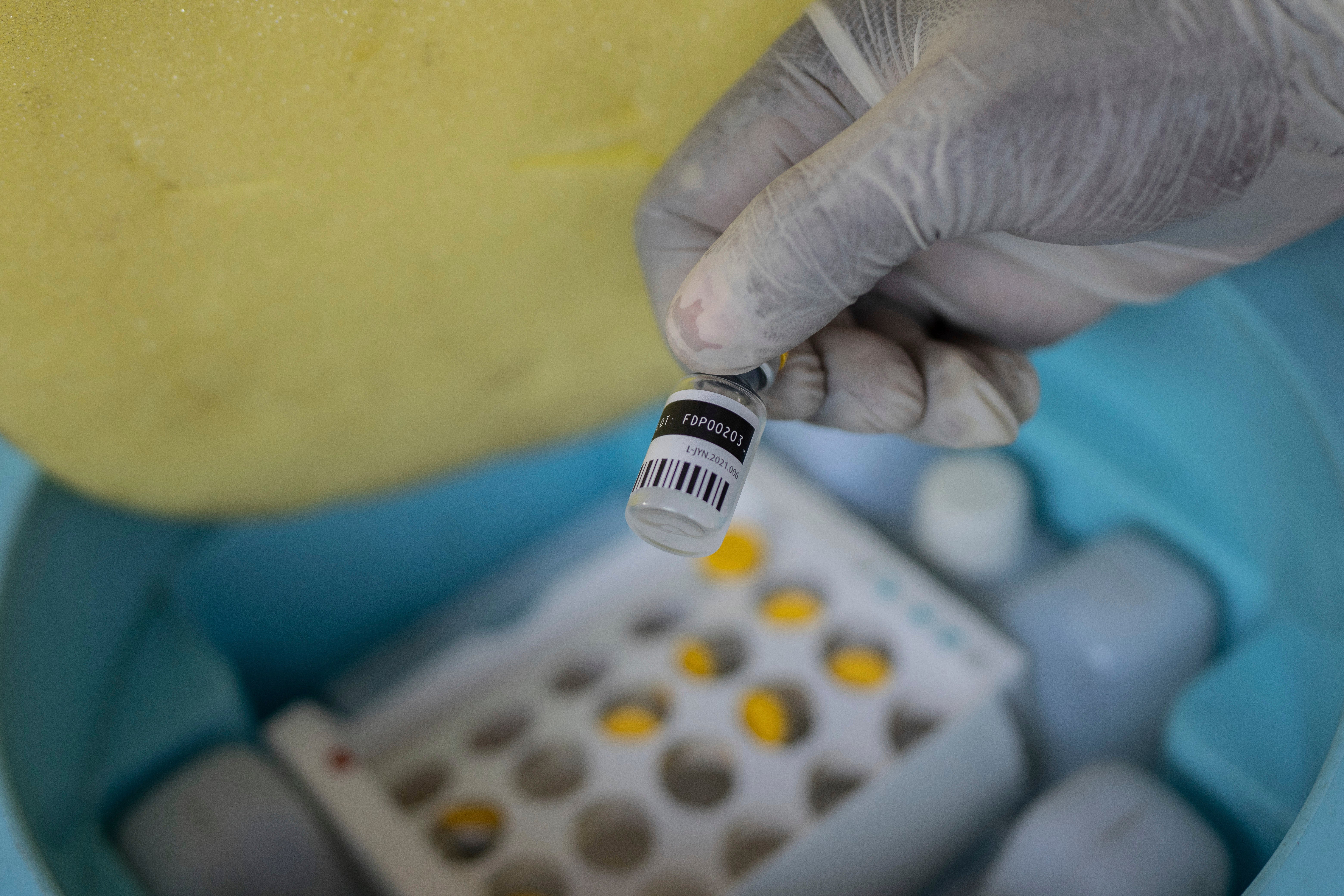 A nurse holds a bottle of mpox vaccine