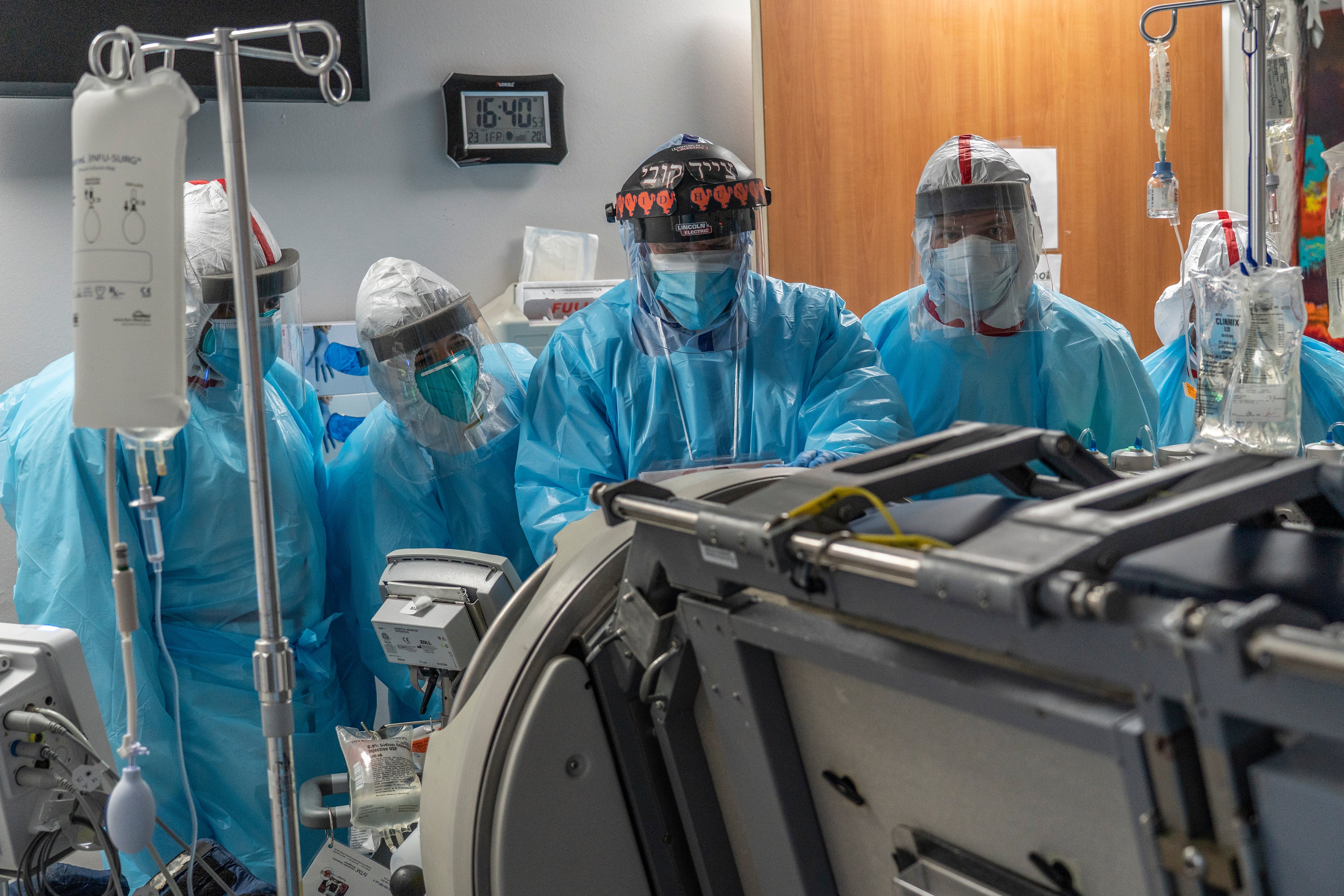 Medical staff members listen while a doctor operates a Roto-prone bed in a patient's room in the COVID-19 intensive care unit (ICU) at the United Memorial Medical Center in 2020. A Kentucky man’s organs were almost harvested, but then he showed signs of life.