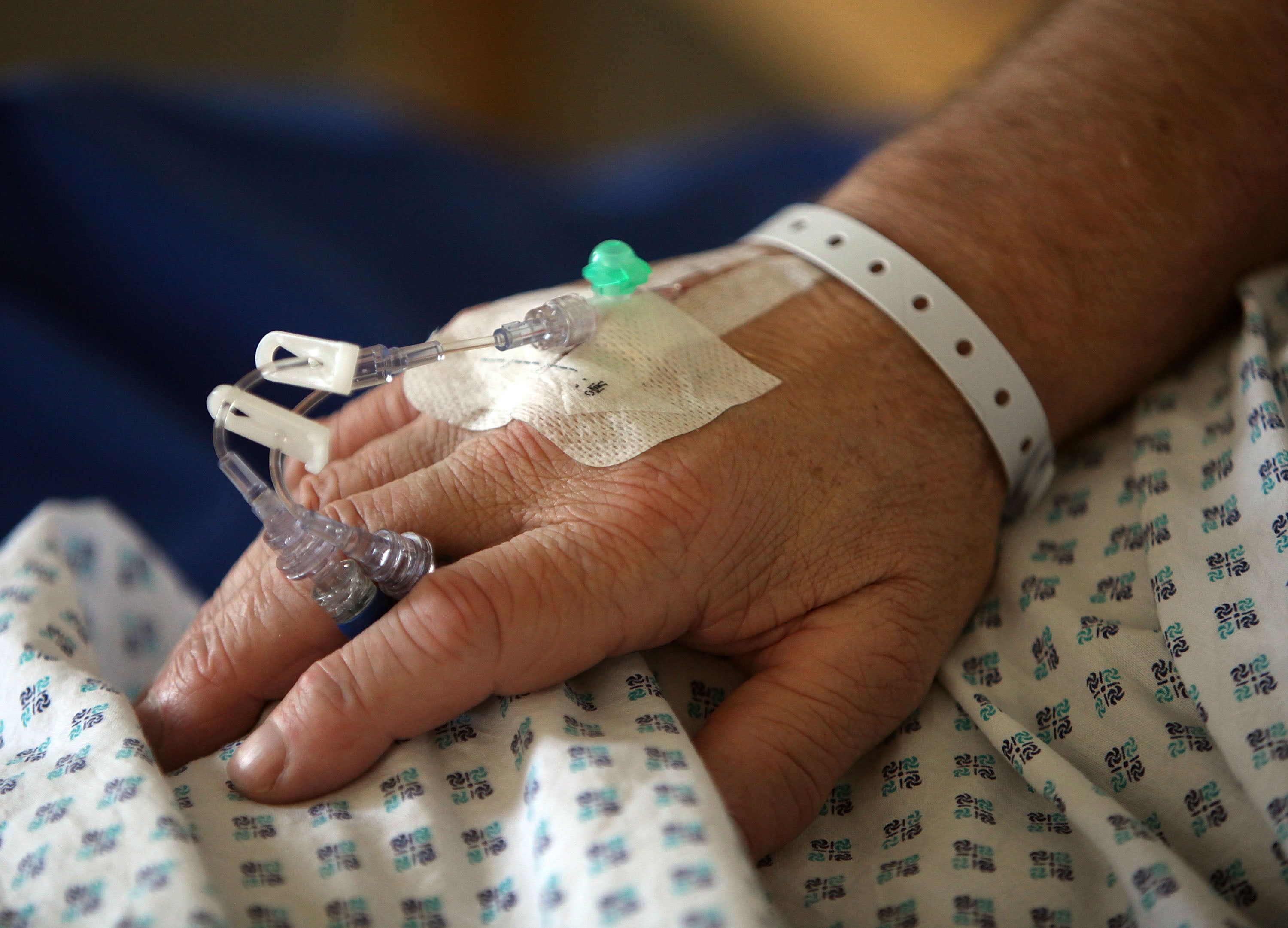 A nurse tends to recovering patients on a general ward at The Queen Elizabeth Hospital