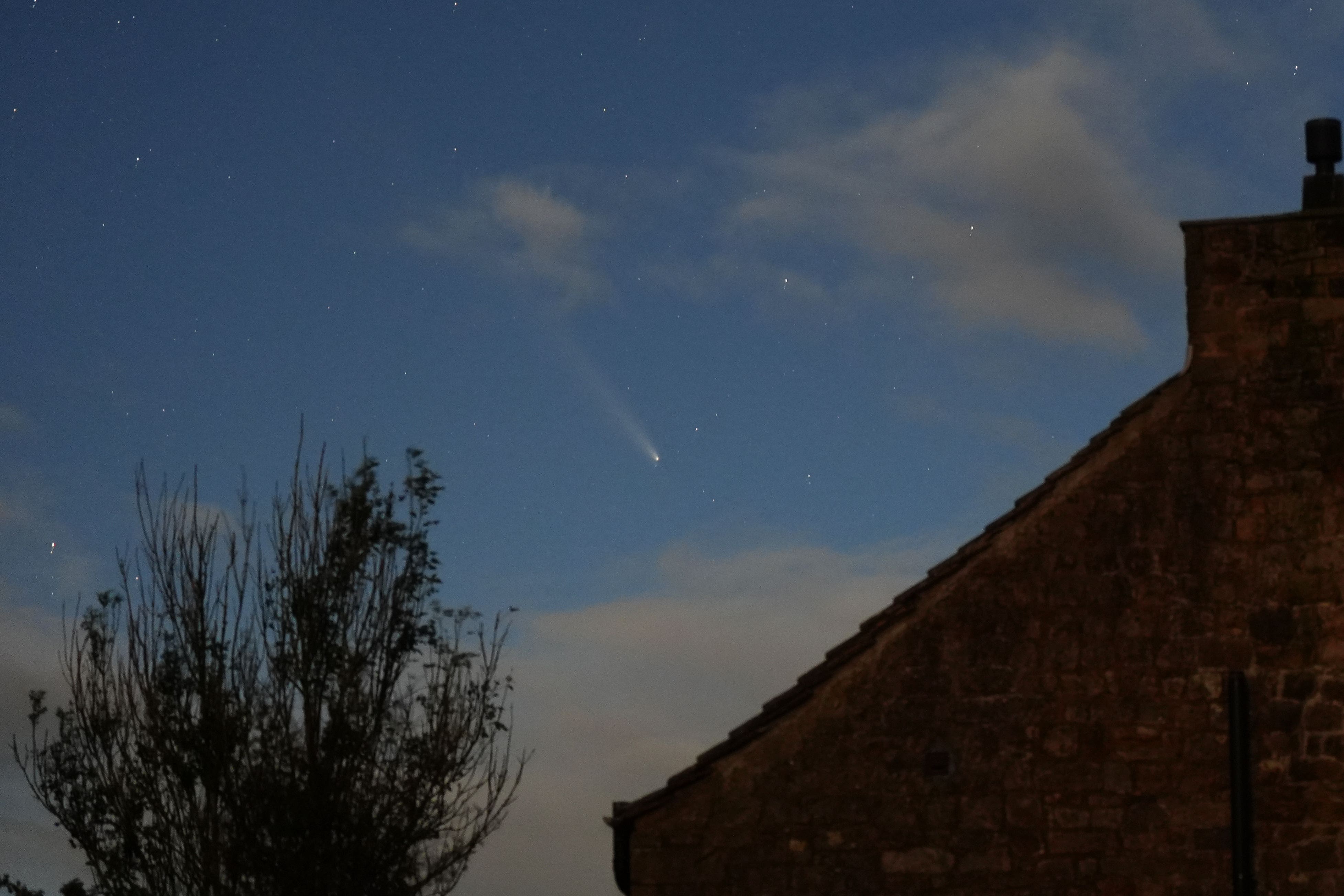 The Comet A3, also known as the Tsuchinshan-Atlas, seen in the skies above the Twice Brewed Inn in the Northumberland International Dark Sky Park (Owen Humphreys/PA)