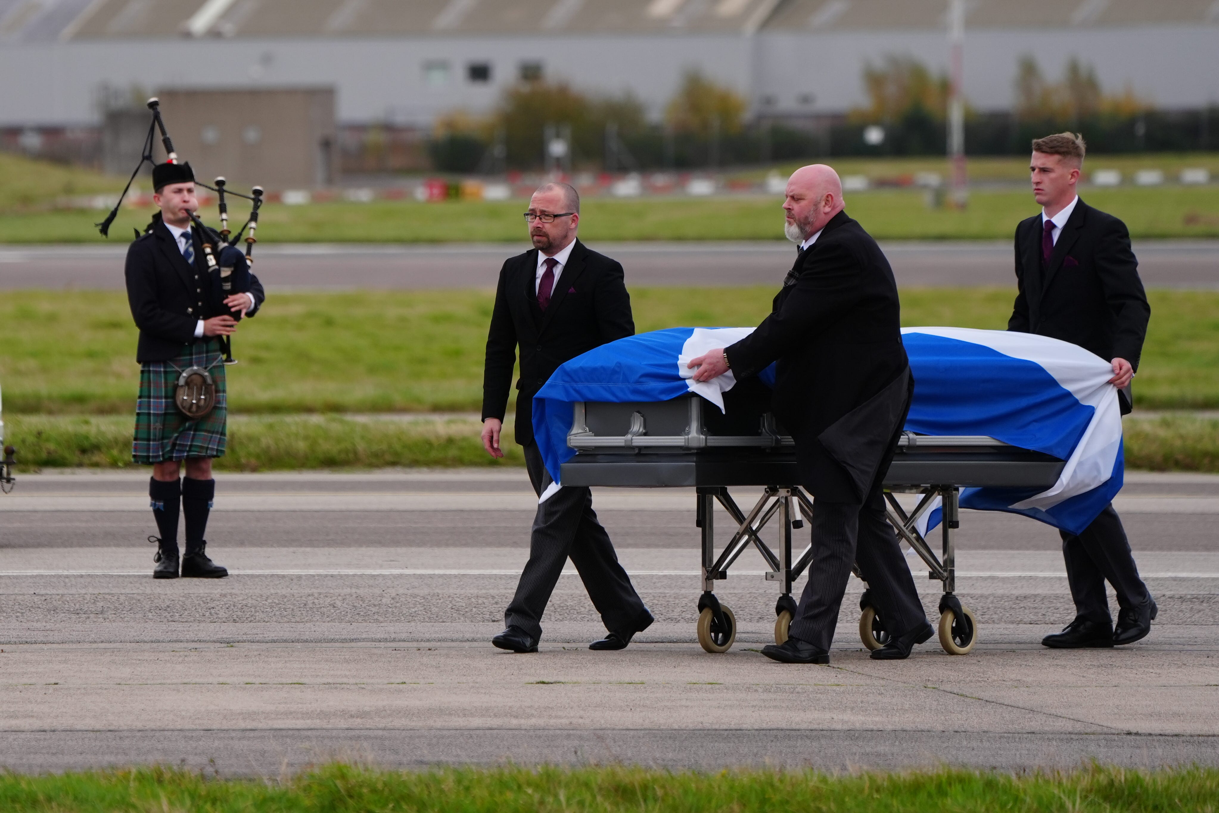 The coffin of former first minister Alex Salmond draped in a Saltire is carried off a plane at Aberdeen Airport (Jane Barlow/PA)