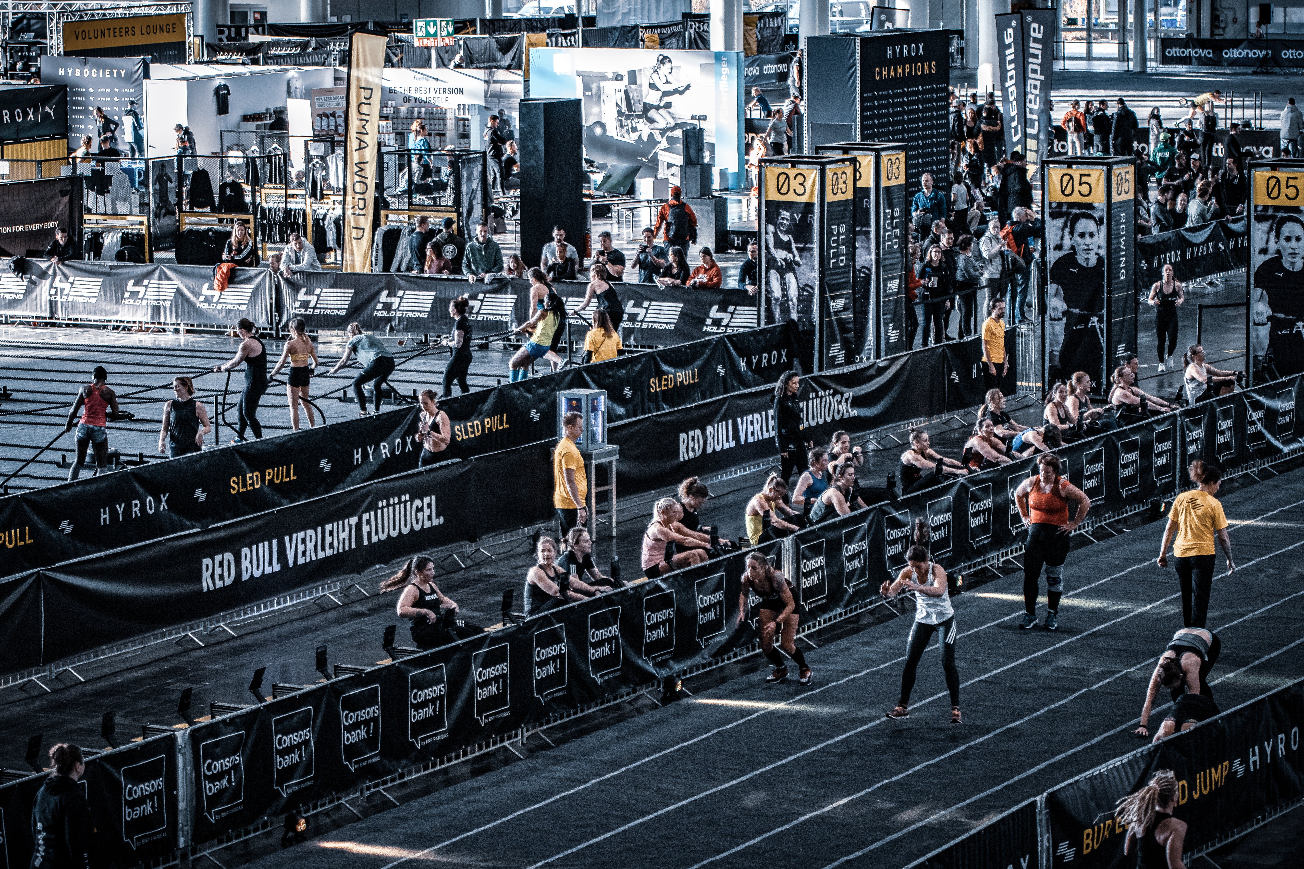 Athletes completing the rowing and burpee broad jump portions of a Hyrox event