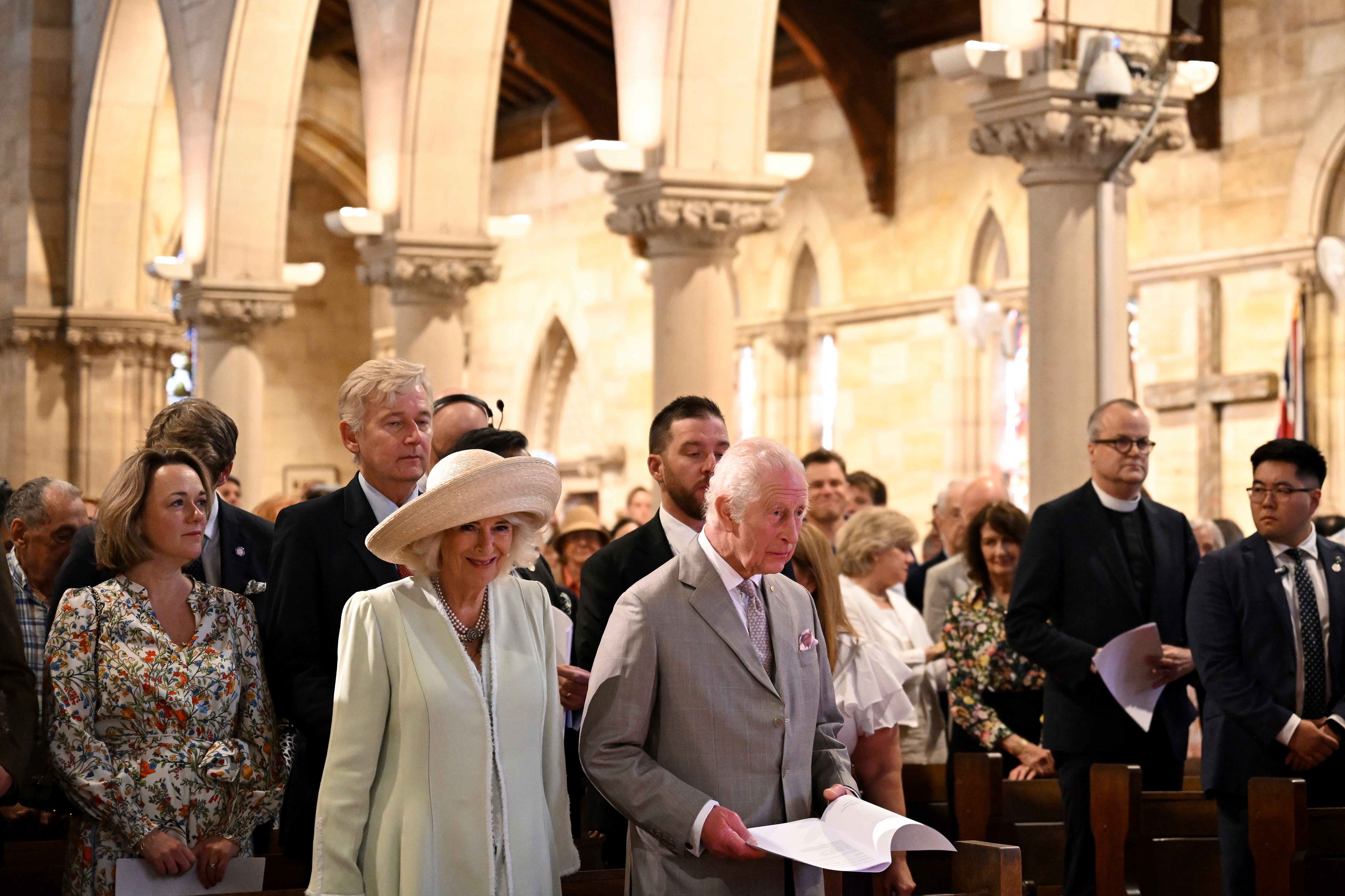 King Charles III, center right, and Queen Camilla, center left, stand during a visit to St Thomas' Anglican Church in Sydney, Sunday, 20 Oct 2024