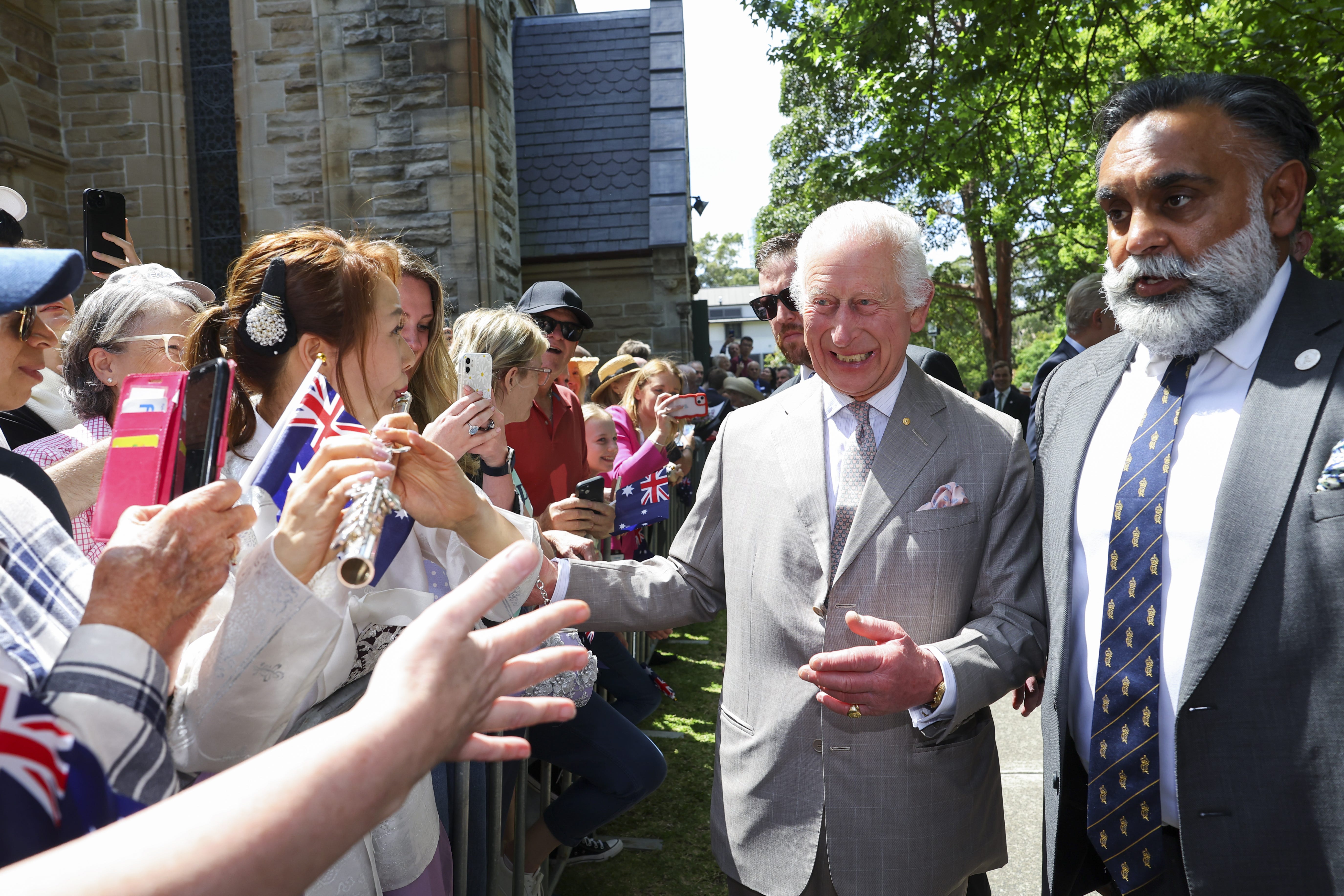 King Charles III greets the crowd outside after attending a Sunday church service at St Thomas’ Anglican Church in north Sydney on day one of their visit to Australia and Samoa (Toby Mellville/PA)