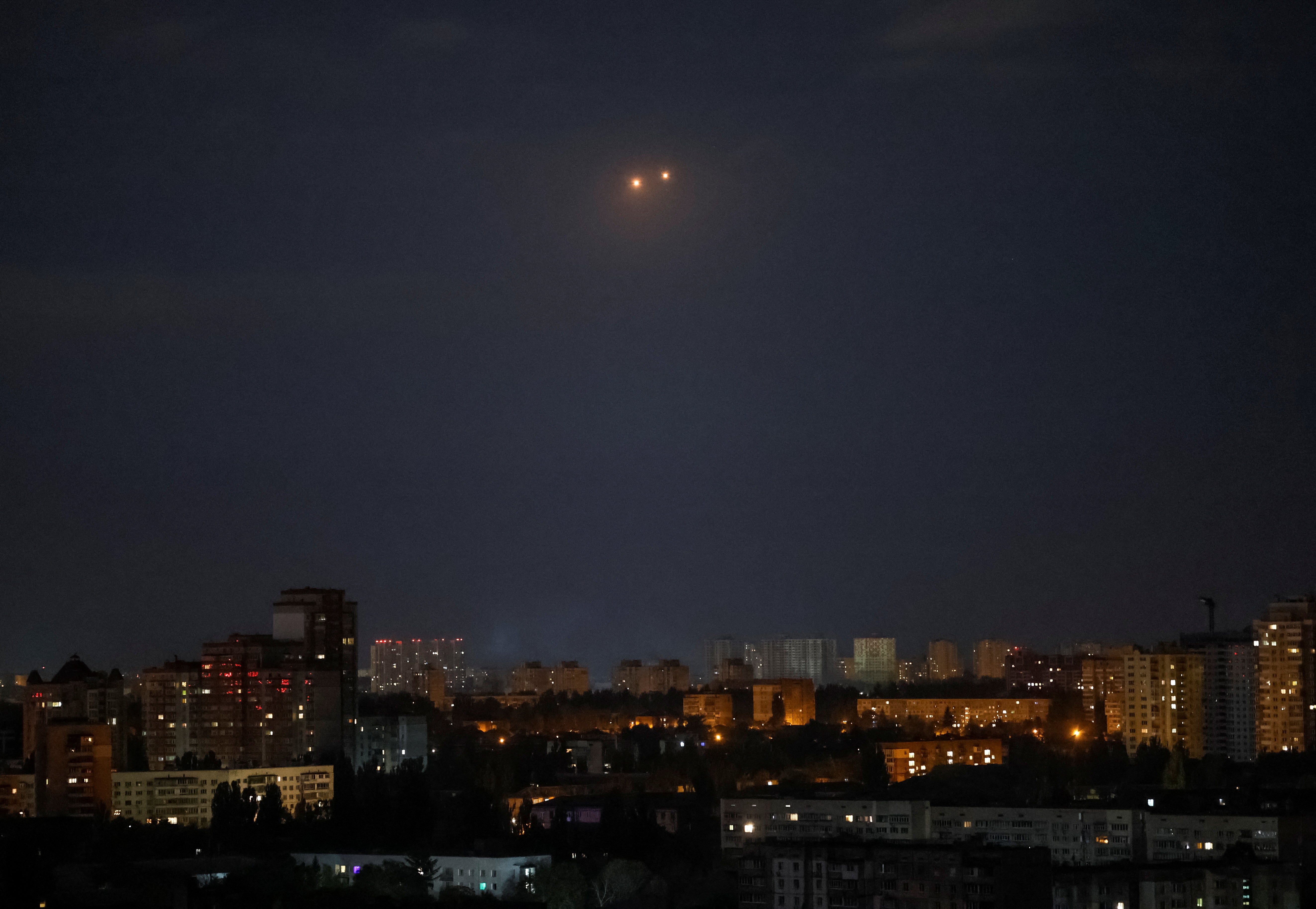 Explosions are seen in the sky over the city during a Russian drone strike