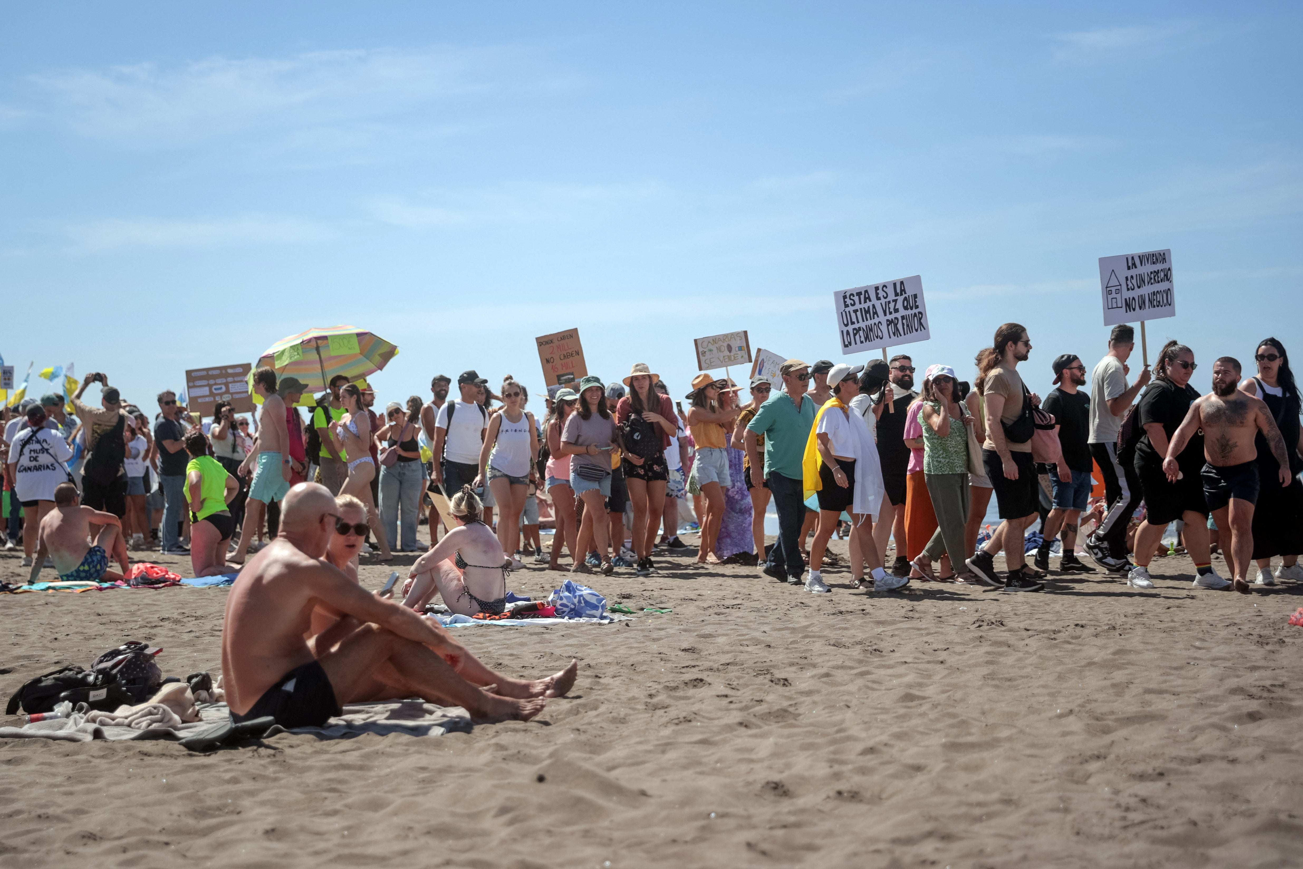 Protesters march on Las Americas beach in Tenerife last year