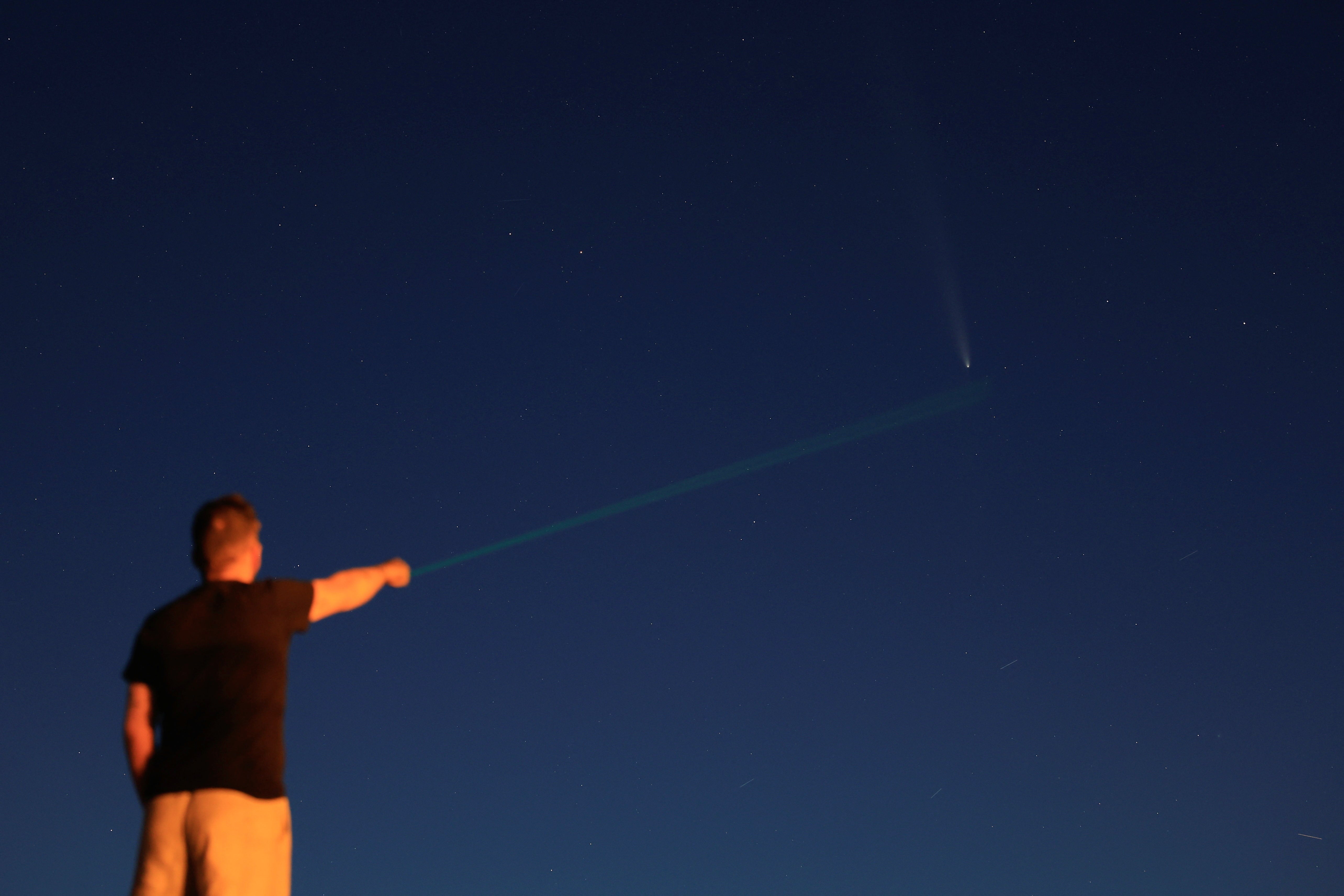 A man with an astronomical laser points out the Comet C/2023 A3 (Tsuchinshan-ATLAS), known as the comet of the century, in Pico De Las Nieves on the island of Gran Canaria, Spain, October 17