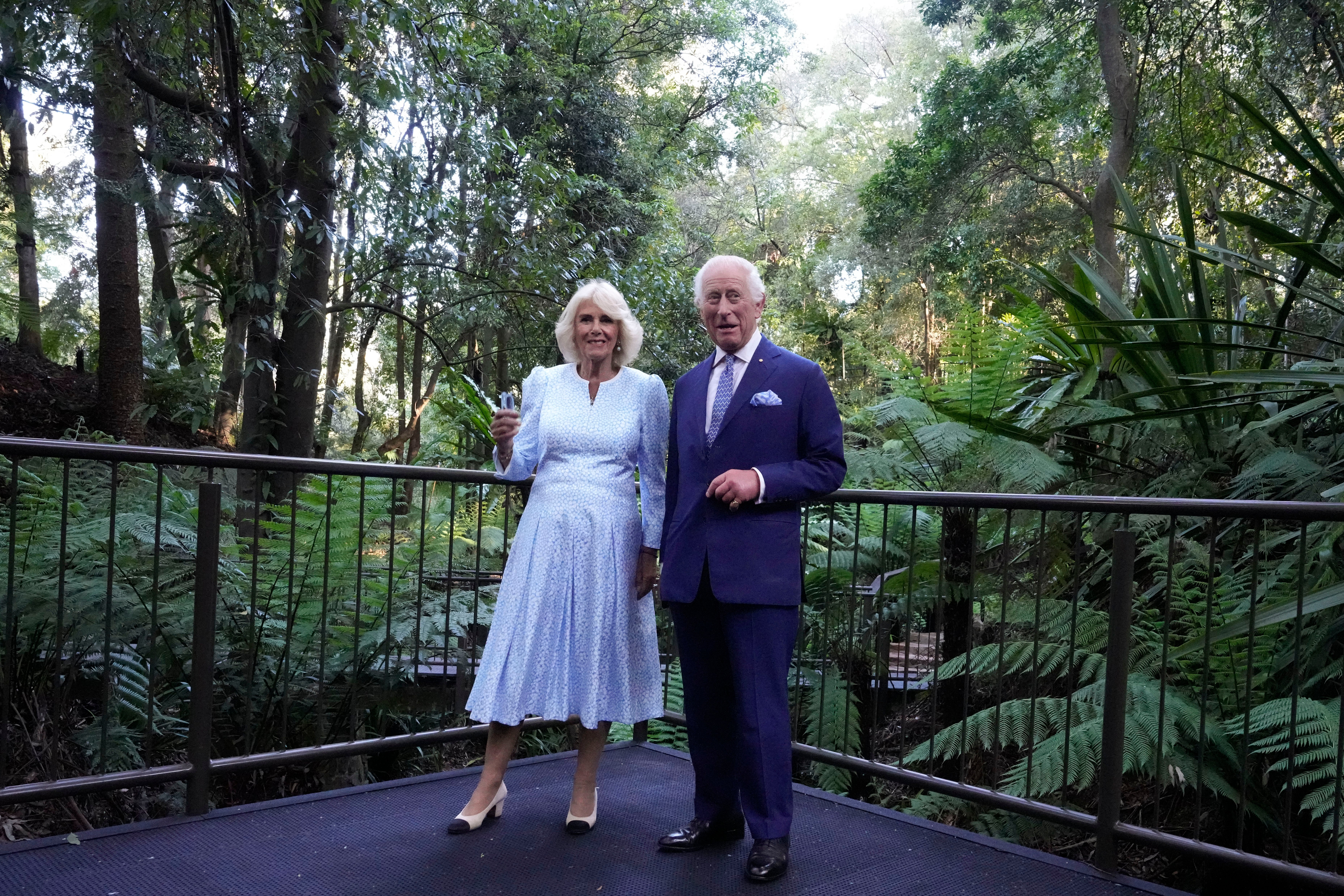 Britain's King Charles III, and Queen Camilla, chats as they walk through the Rainforest Gully at the Australian National Botanic Gardens in Canberra,