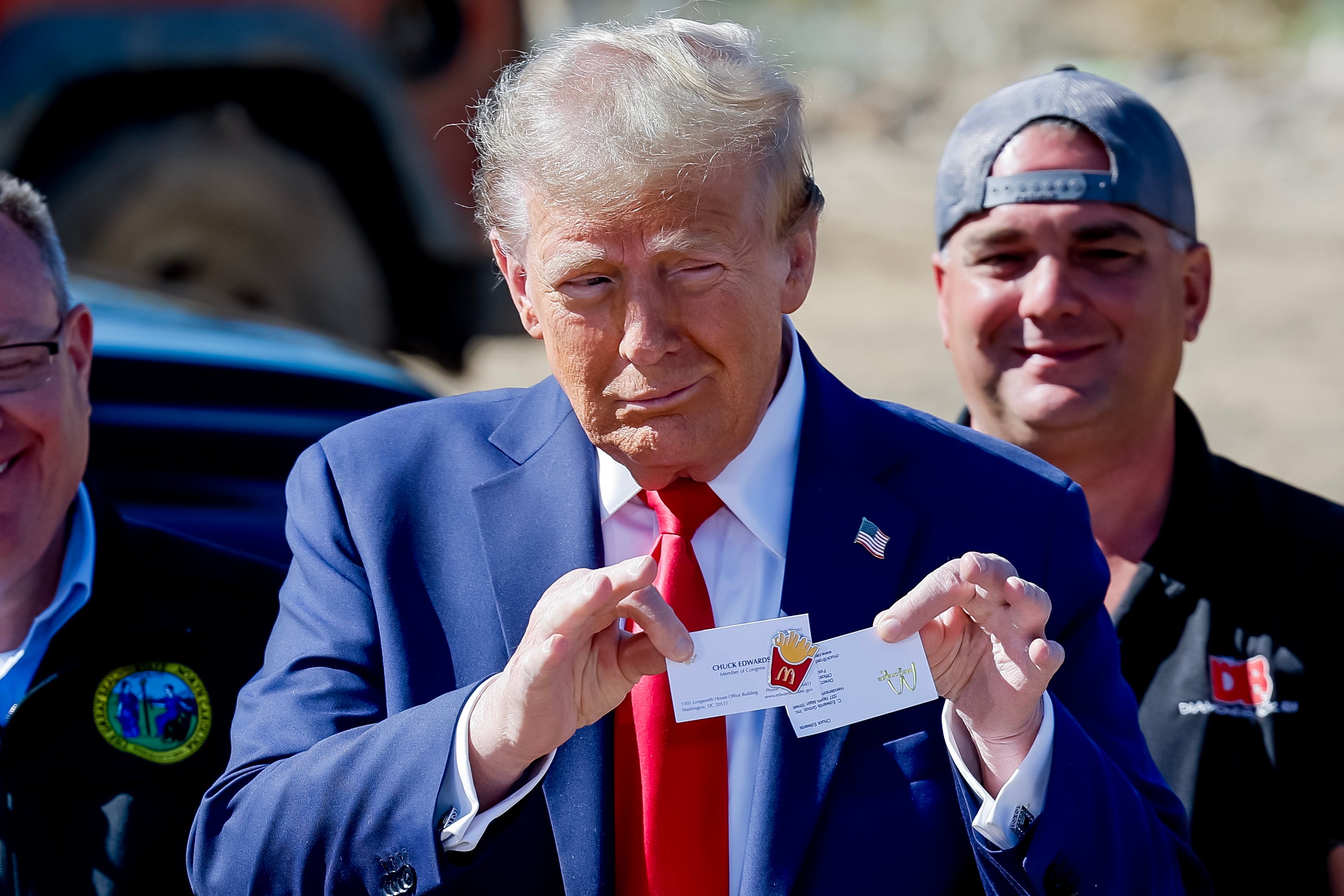 Former president and Republican presidential nominee Donald Trump holds an official McDonald’s fries cook pin given to him during a tour of Hurricane Helene’s devastation on October 21