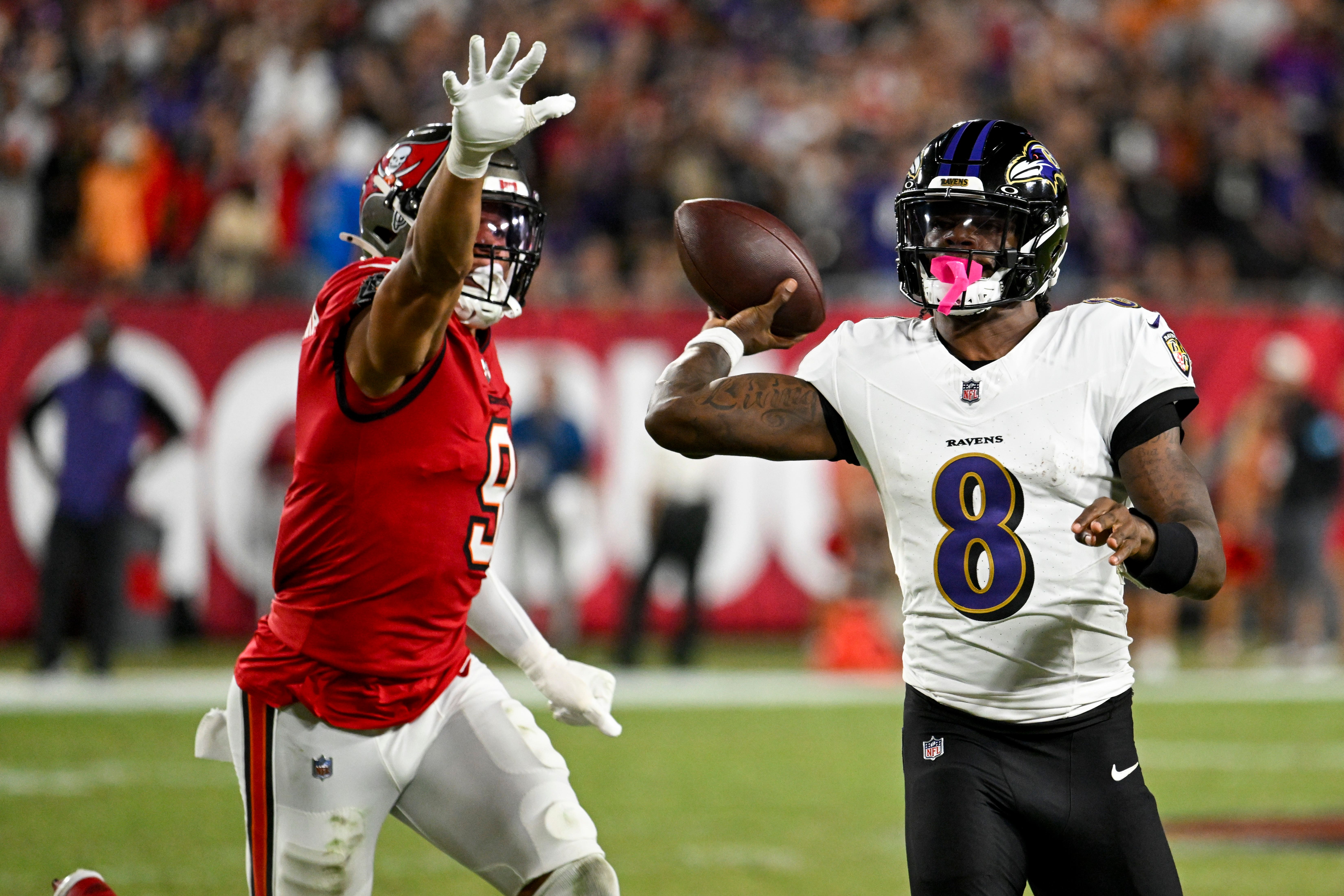 Baltimore Ravens quarterback Lamar Jackson is pressured by Tampa Bay Buccaneers linebacker Joe Tryon-Shoyinka (Jason Behnken/AP)