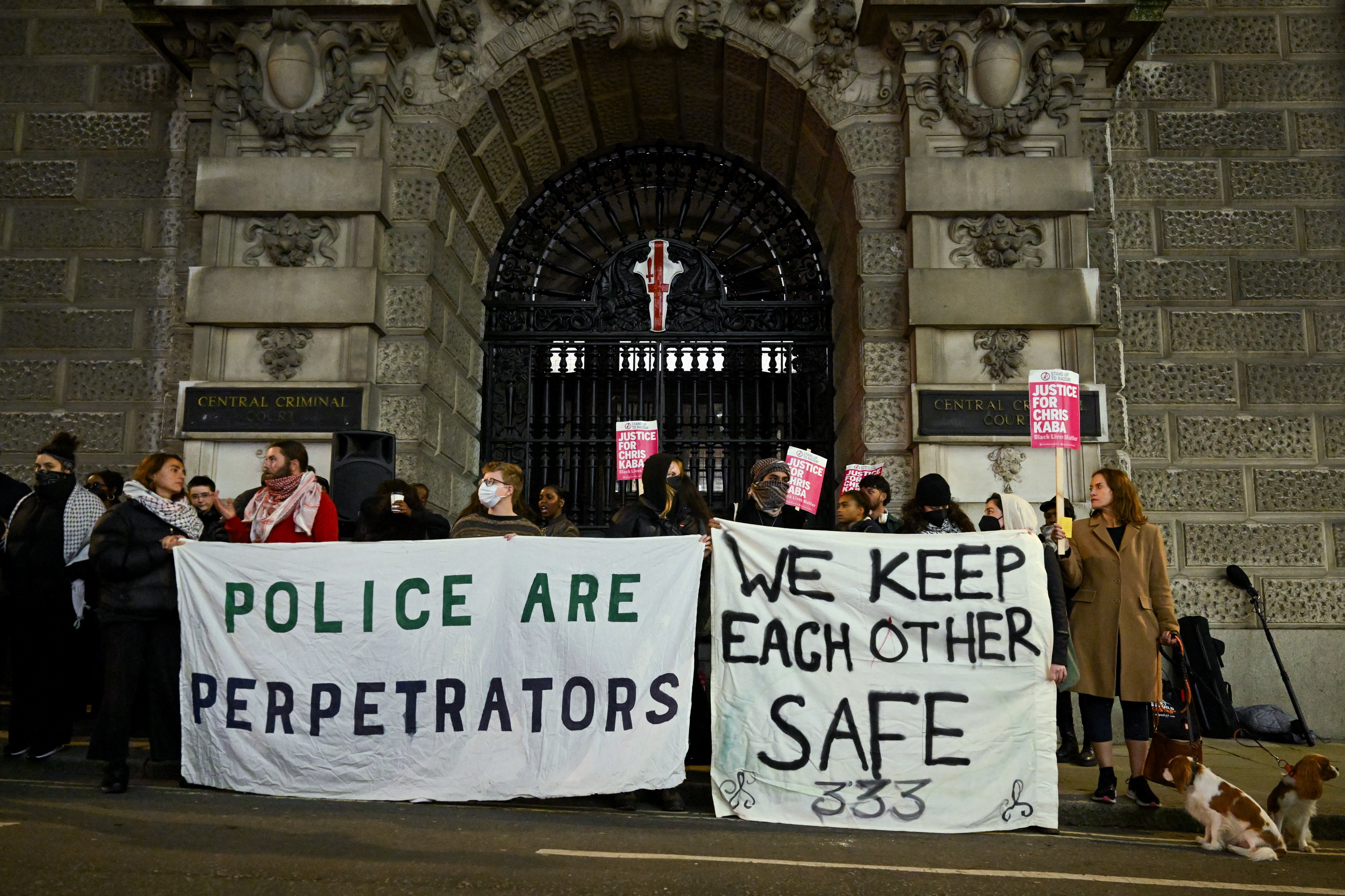 Dozens of protesters gathered outside the Old Bailey on Monday evening