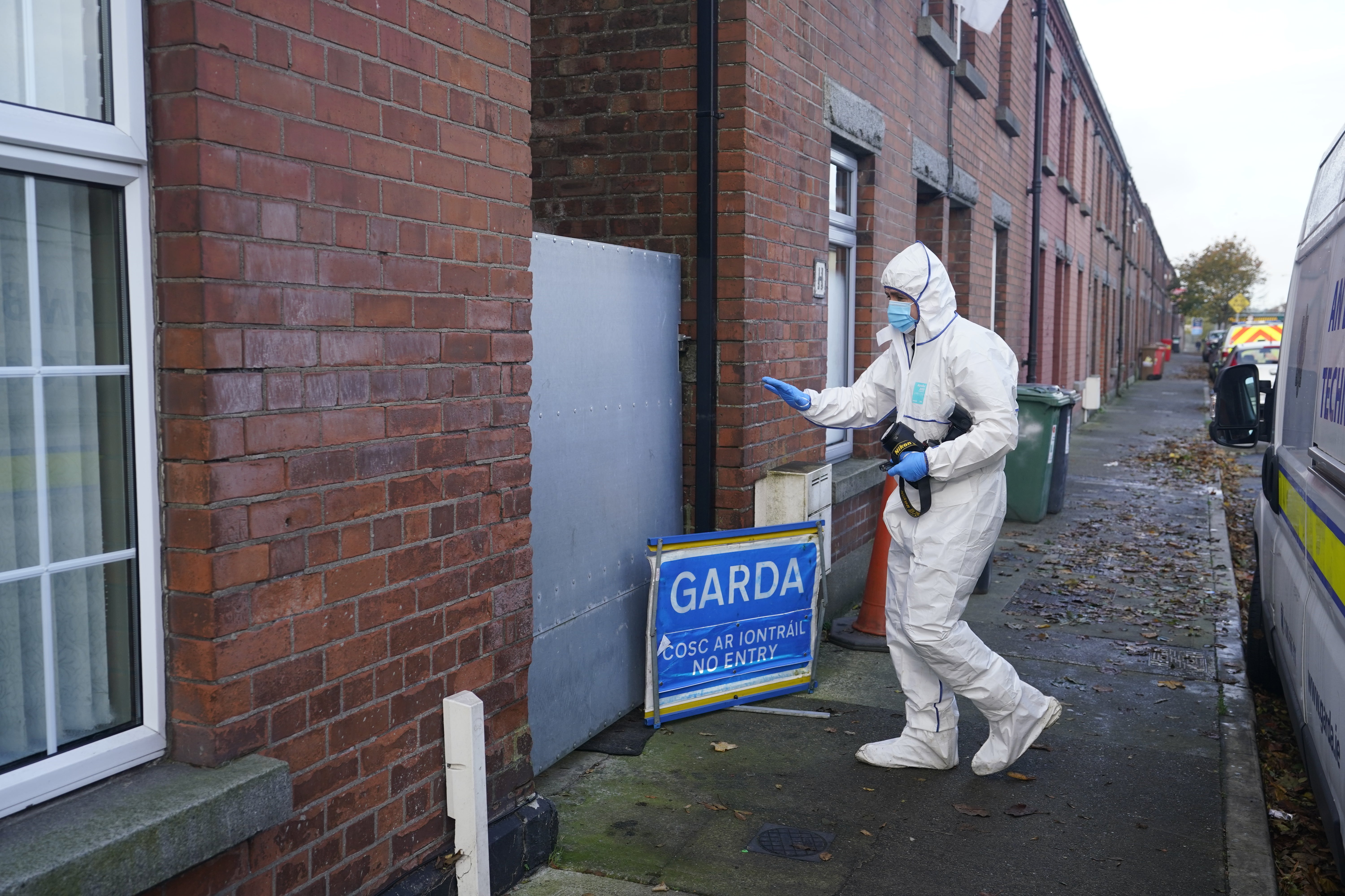 A Gardai forensic officer outside the property in Dundalk, Co Louth (Niall Carson/PA)