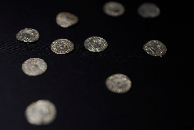 <p>A selection of coins dating from around the Norman invasion in 1066, part of the Chew Valley Hoard, on display at the British Museum (Alastair Grant/AP)</p>