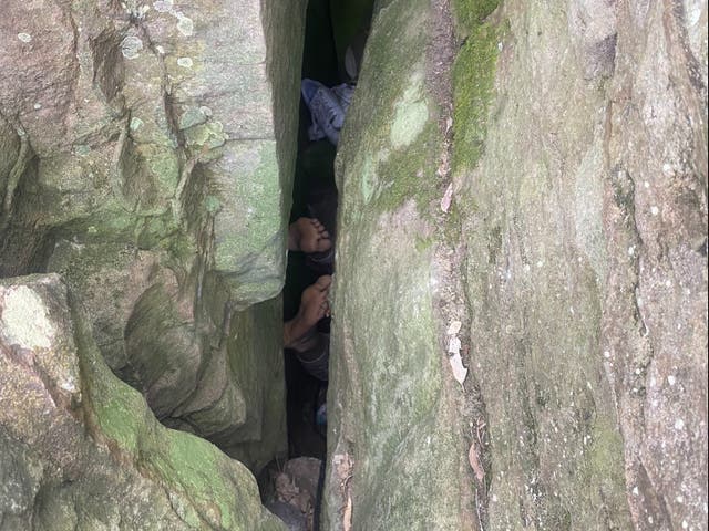 <p>The woman became trapped between the boulders while trying to reach her phone </p>