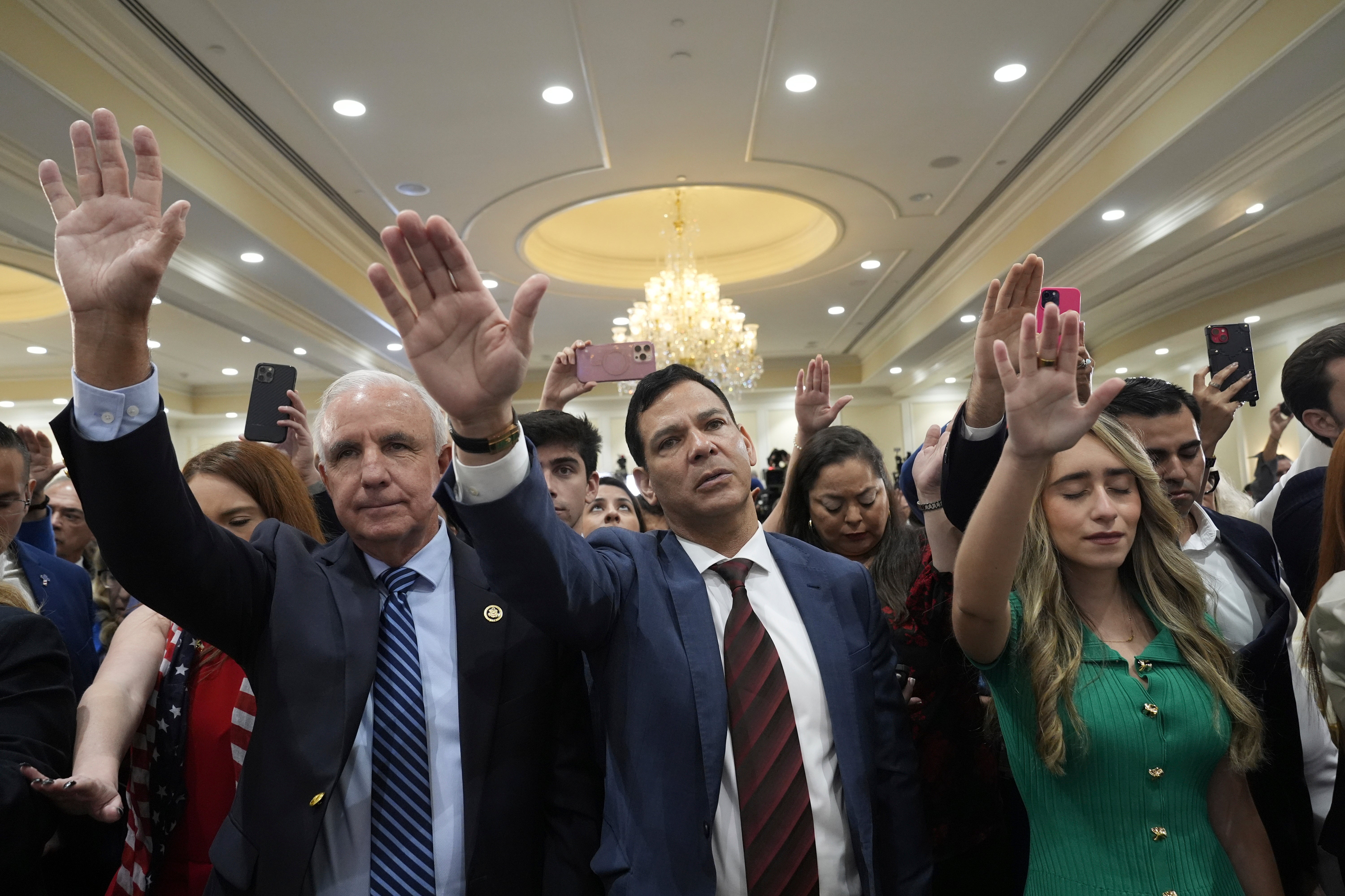 Participants pray for Republican presidential nominee Trump during a roundtable discussion in Florida